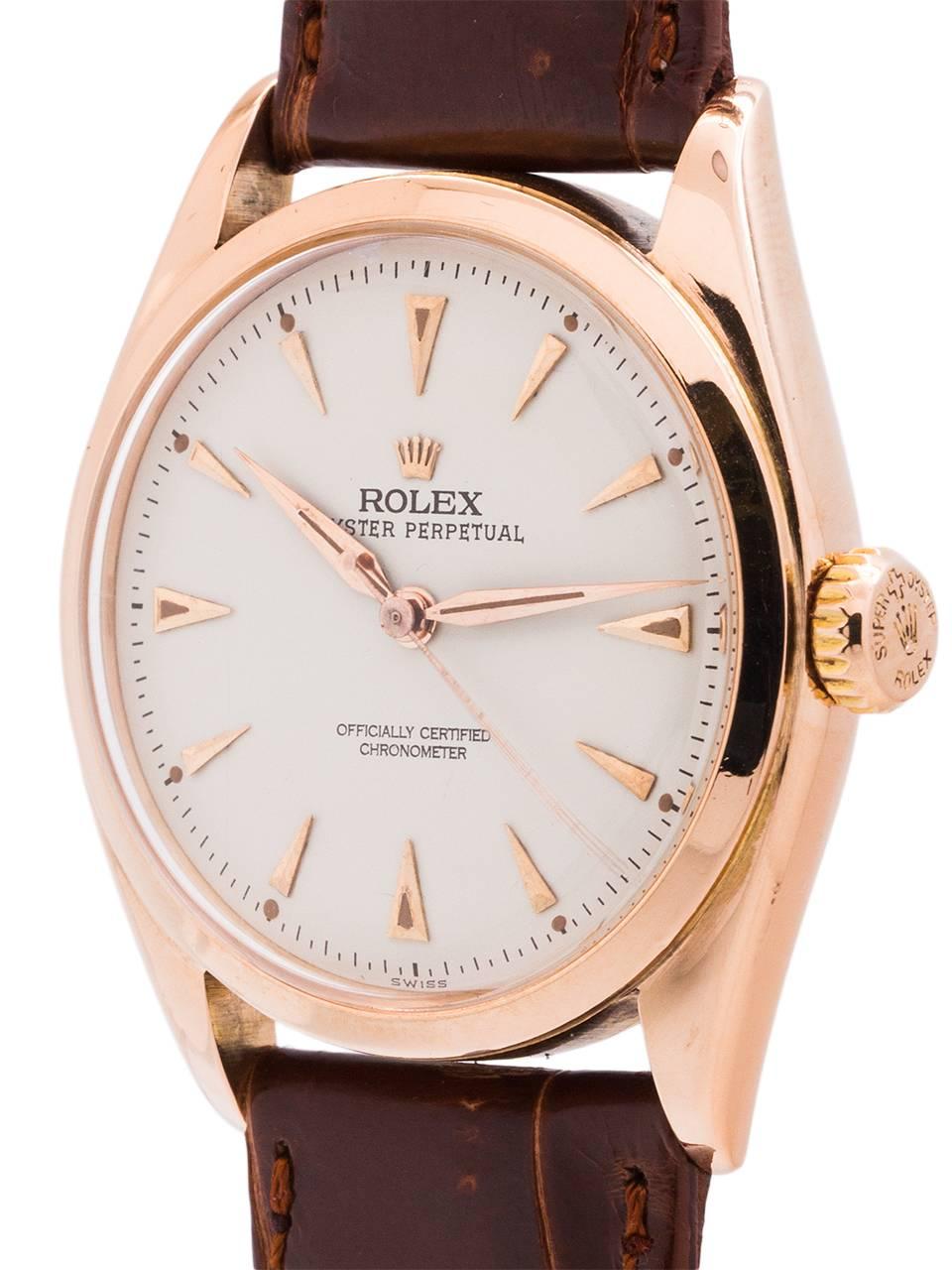 
Rolex 18K PG Oyster Perpetual ref# 6084 serial # 698,xxx circa 1952. Featuring a 34mm diameter case with smooth bezel and acrylic crystal. Very pleasing restored antique white dial with rose gold triangular indexes, applied rose gold Rolex crown