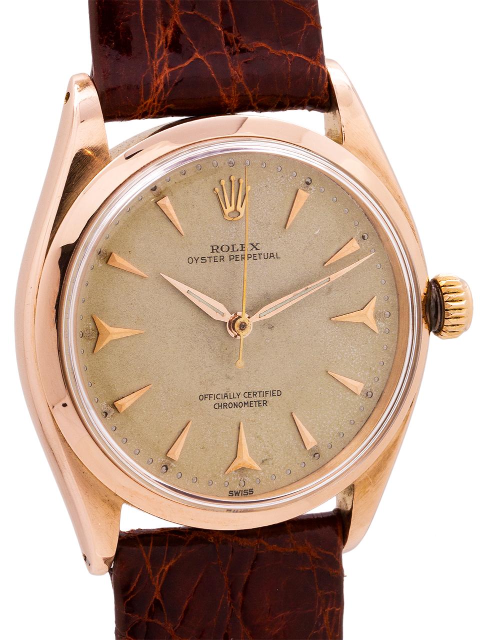 
Rolex 18K rose gold Oyster Perpetual reference# 6564 serial# 157,xxx circa 1956. Featuring  a 34mm diameter case with smooth bezel with acrylic crystal and an especially beautiful condition original matte salmon dial with rose gold applied shark’s