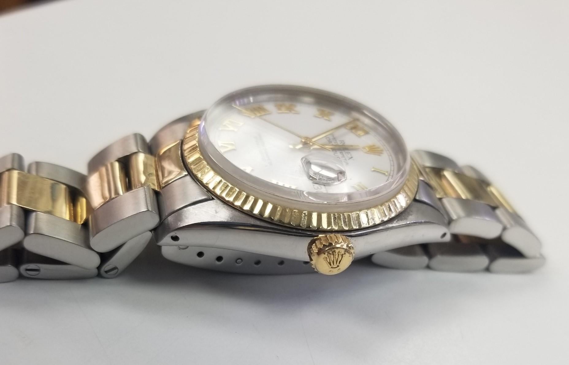 Rolex Date 34mm White White Dial Roman Numeral
Accent Dial 2 Tone Oyster Band 
Creator: Rolex
Design: Datejust Watch Datejust Collection
Case Material: 18k Gold and Stainless Steel
Strap Material: 18k Gold and Stainless Steel
Serial number: