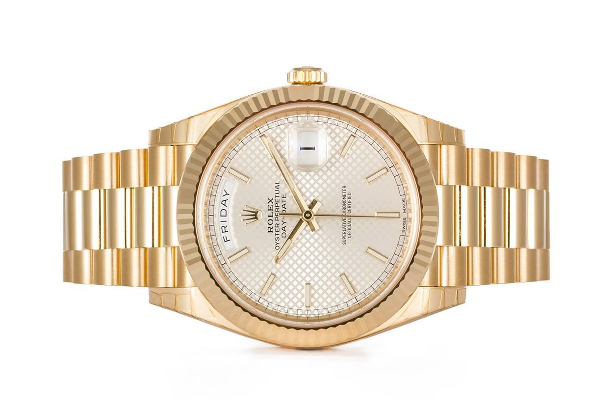 We are pleased to offer this Rolex 18k Yellow Gold Day-Date 40 President 228238. This is the newer larger version of the classic mens Rolex Day-Date dress watch. It is in excellent condition and still has the factory protective stickers on it. This