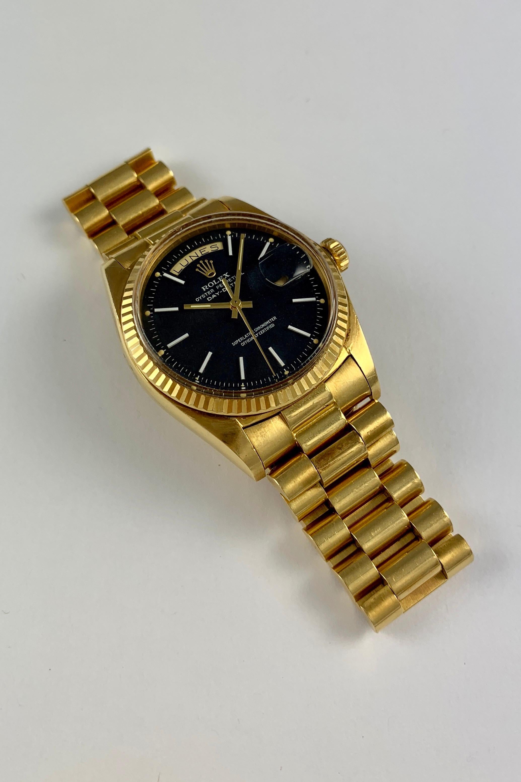 Rolex 18K Yellow Gold Day-Date Presidential Watch from the Early 1970's
Beautiful Factory Black Matte Confetti Dial with Rare White Applied Hour Markers and Perfect Lume Plots Below the Hour Markers
Yellow Gold Fluted Bezel
18K Yellow Gold Case
36mm