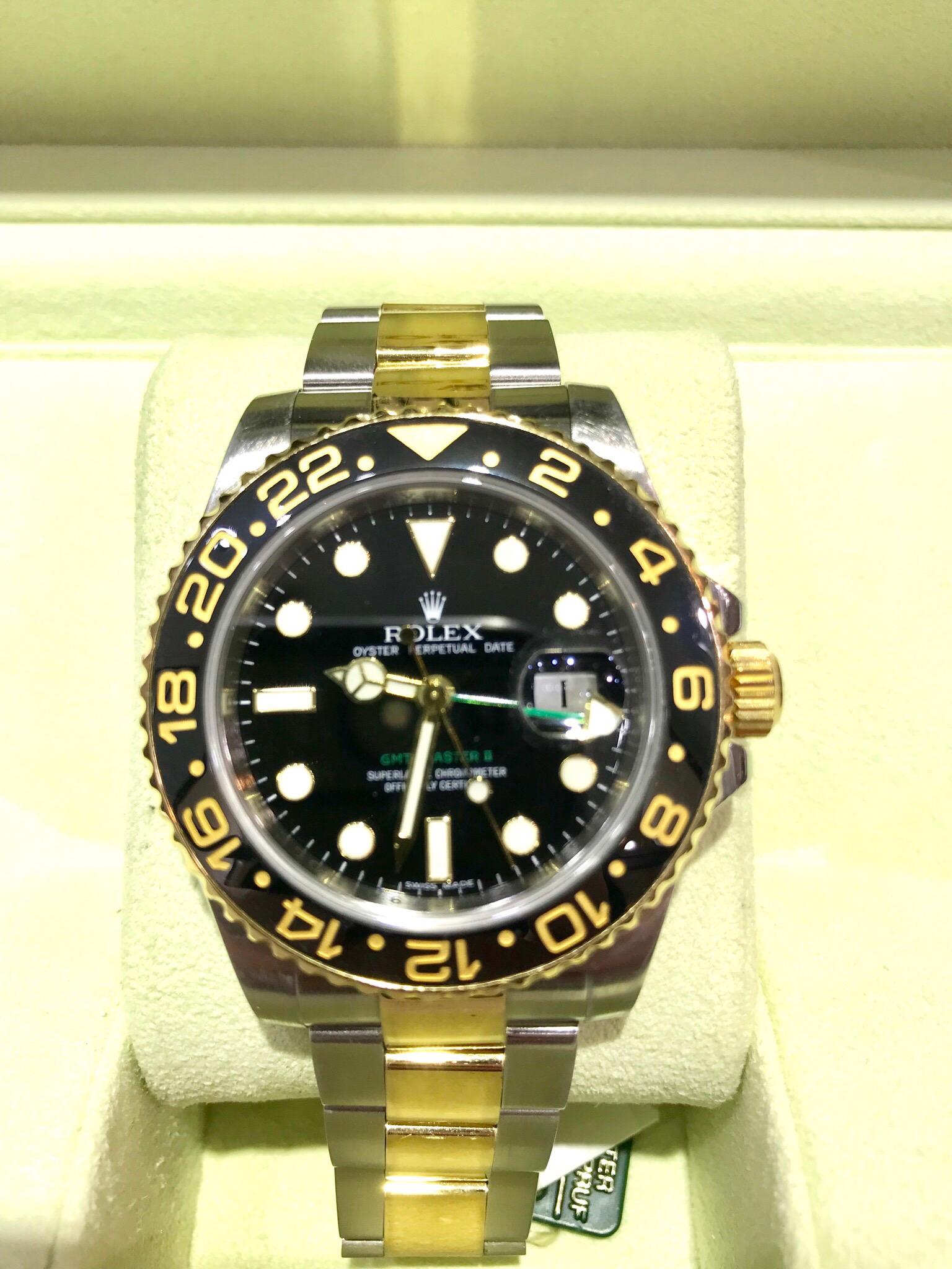 An excellent condition iconic Rolex GMT Master II with a ceramic bezel.  The watch features the Oyster bracelet, made up of solid 18 karat yellow gold and stainless steel links.  This watch has the original box and papers, including the warranty