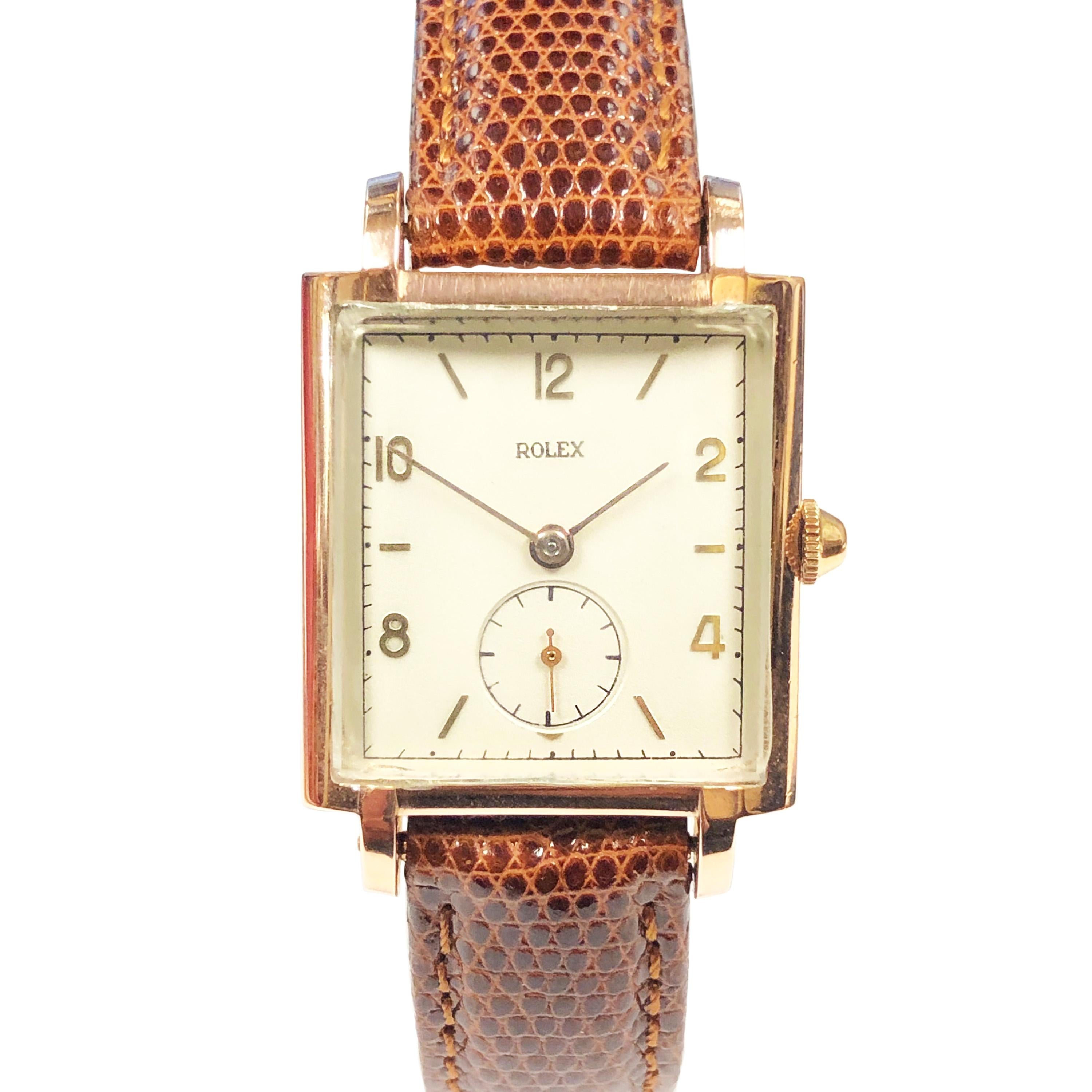 Circa 1940 Rolex Wrist Watch, 39 X 27 MM 2 piece case with a Rose Gold Shell Top and a Stainless Steel Back. 17 Jewel Mechanical, Manual wind Movement, original and mint condition Silver - White Dial with Raised Gold Markers. New L.W. Swiss Brown