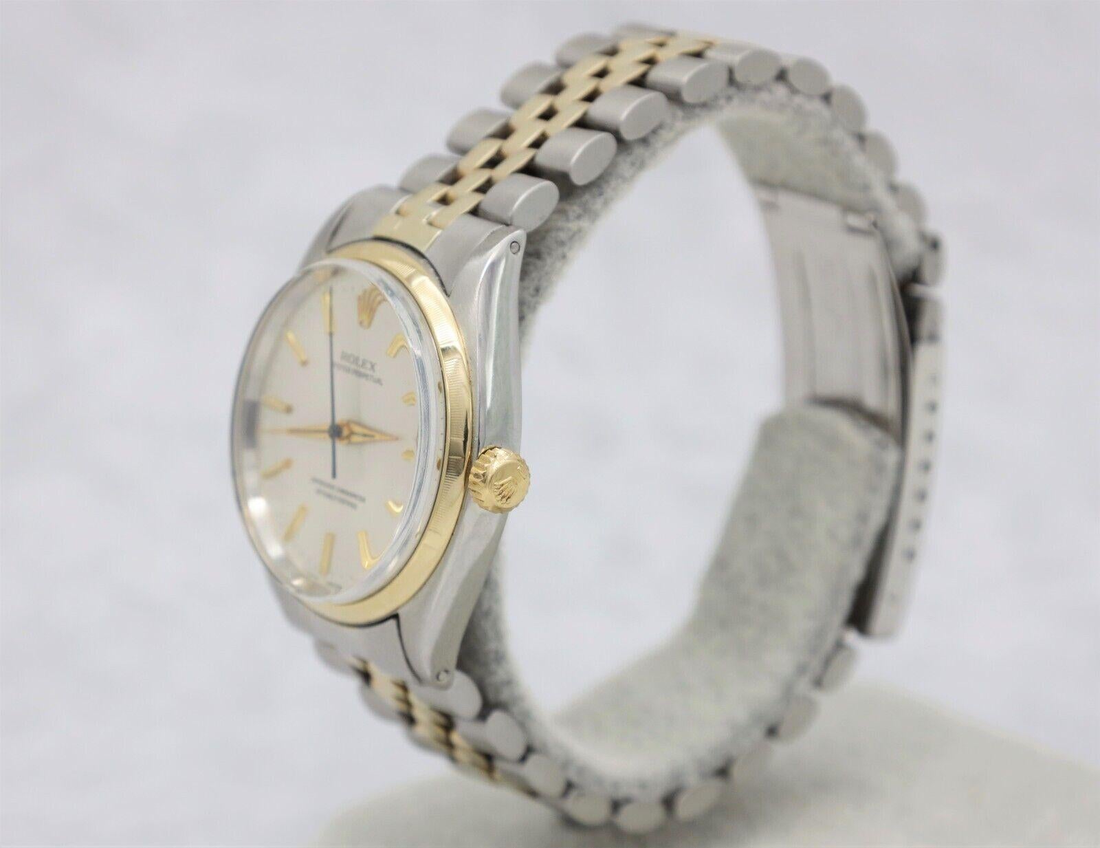 This iconic two tone Rolex Oyster Perpetual watch blends luxury and functionality into a classic formal wrist watch. The exquisite dial features 14k yellow gold stick indices and the Rolex crown as the 12hr mark. Typical for this band style, it does