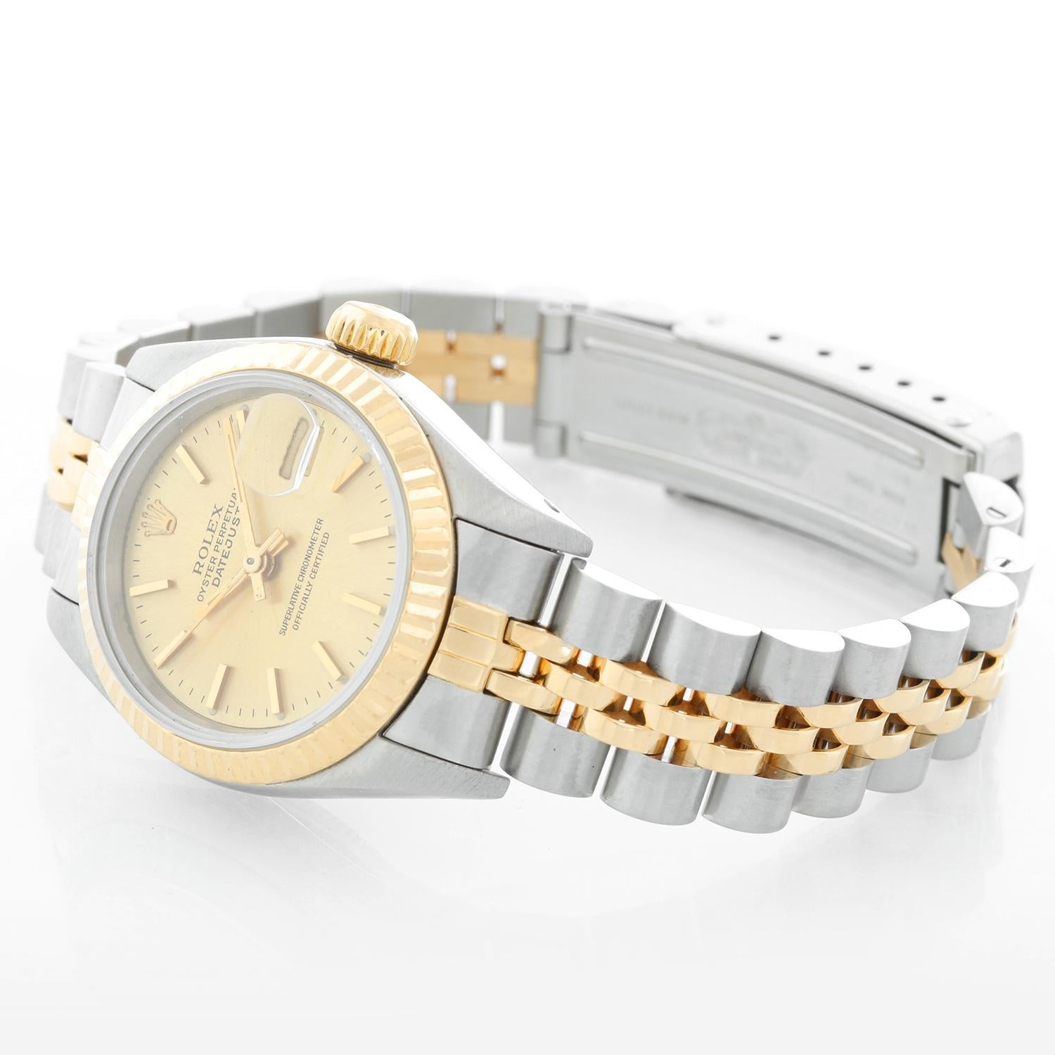 Rolex  2-Tone Datejust Steel & Gold Ladies Watch 69173 - Automatic winding, 29 jewels, Quickset date, sapphire crystal. Stainless steel case with 18k yellow gold fluted bezel . Champagne dial with gold stick markers. Stainless steel and 18k yellow
