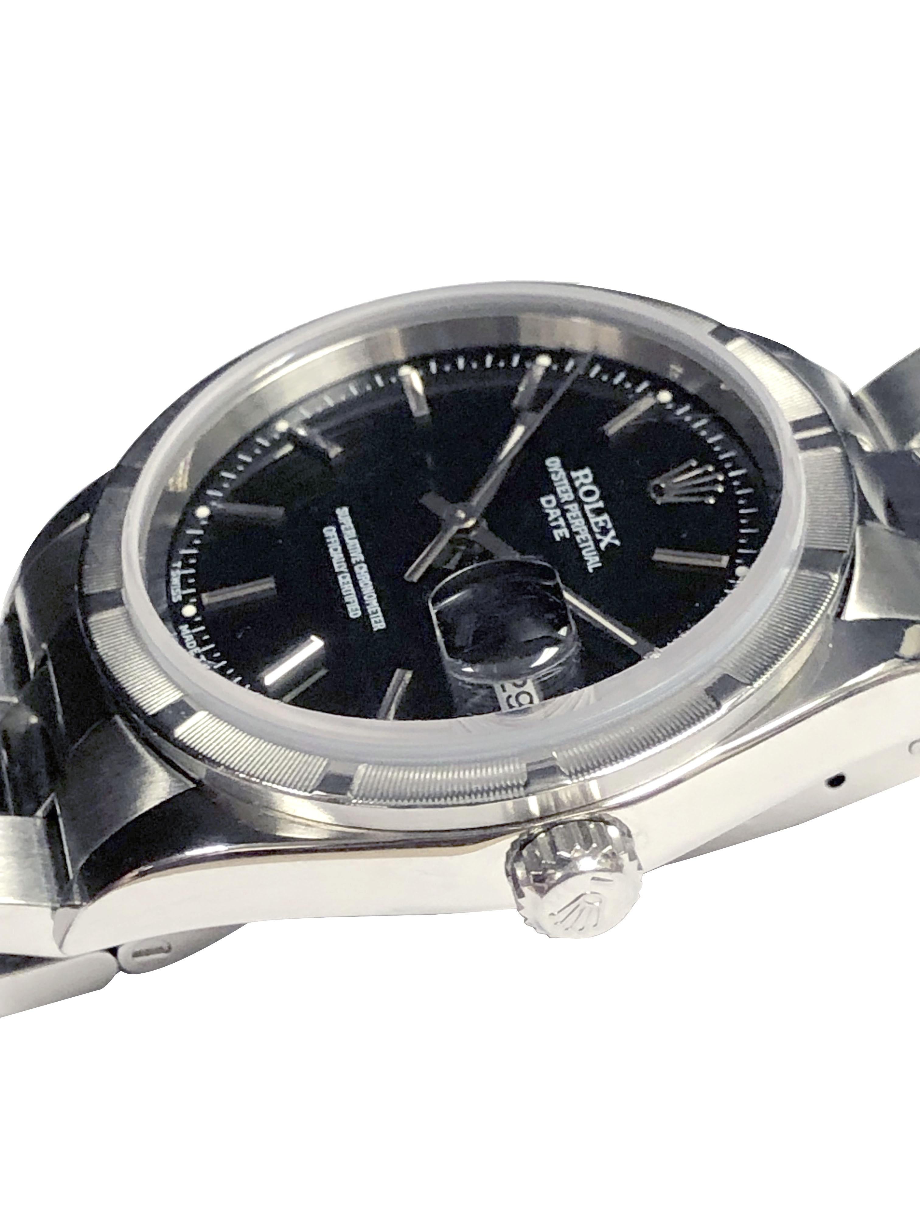 Circa 2000 Rolex Date Model Wrist Watch, 34 M.M. Stainless Steel 3 Piece case with Engine Turned Bezel, Caliber 3135 Automatic, self winding movement. Black Dial with Raised Silver Baton Markers, sweep seconds hand and a Calendar window st the 3