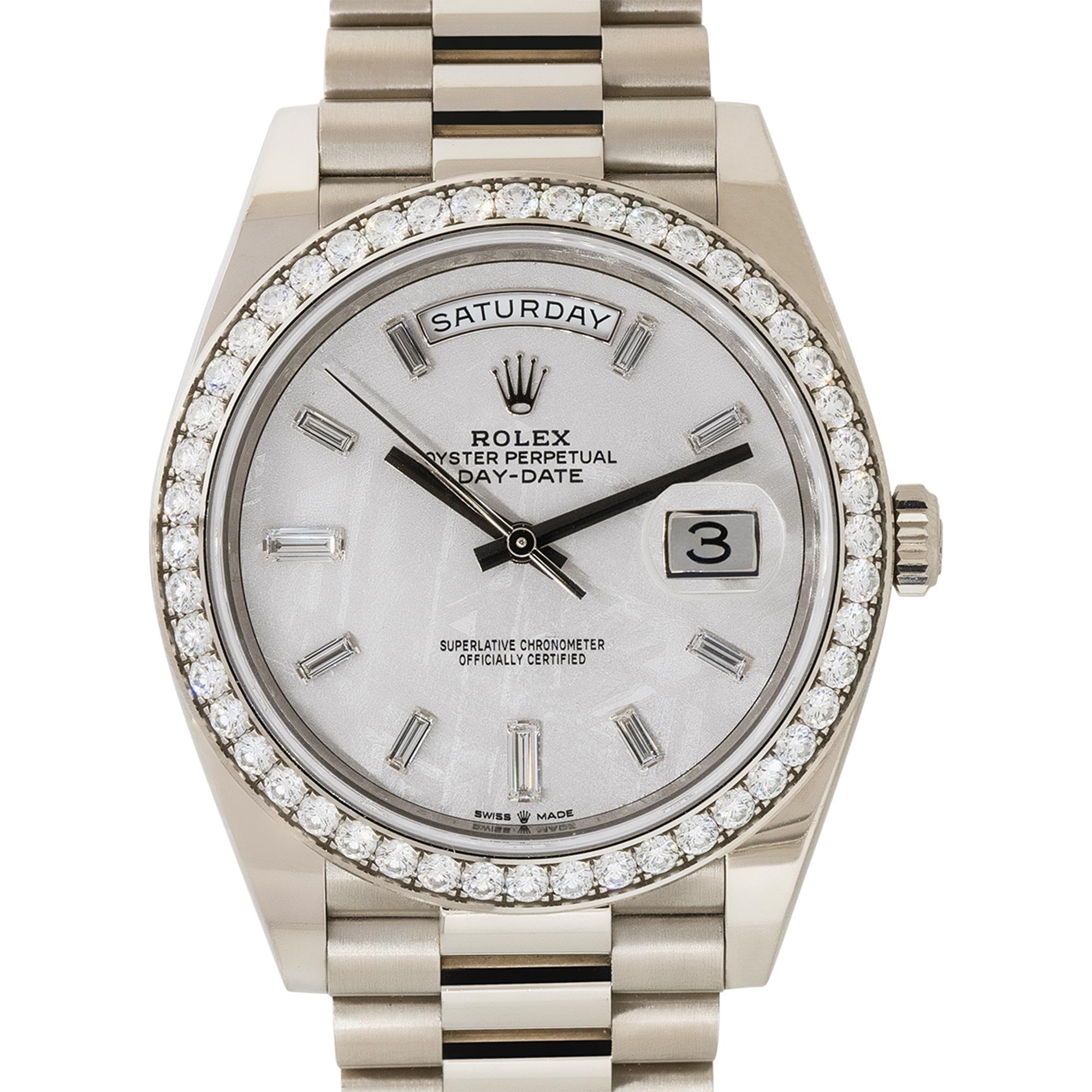 Brand: Rolex
Case Material: 18k White Gold
Case Diameter: 40mm
Crystal: Sapphire Crystal
Bezel: 18k white gold bezel with Diamonds
Dial: Meteorite dial with white gold hands and Diamond hour markers.Date can be found at 3 o'clock as well as day at