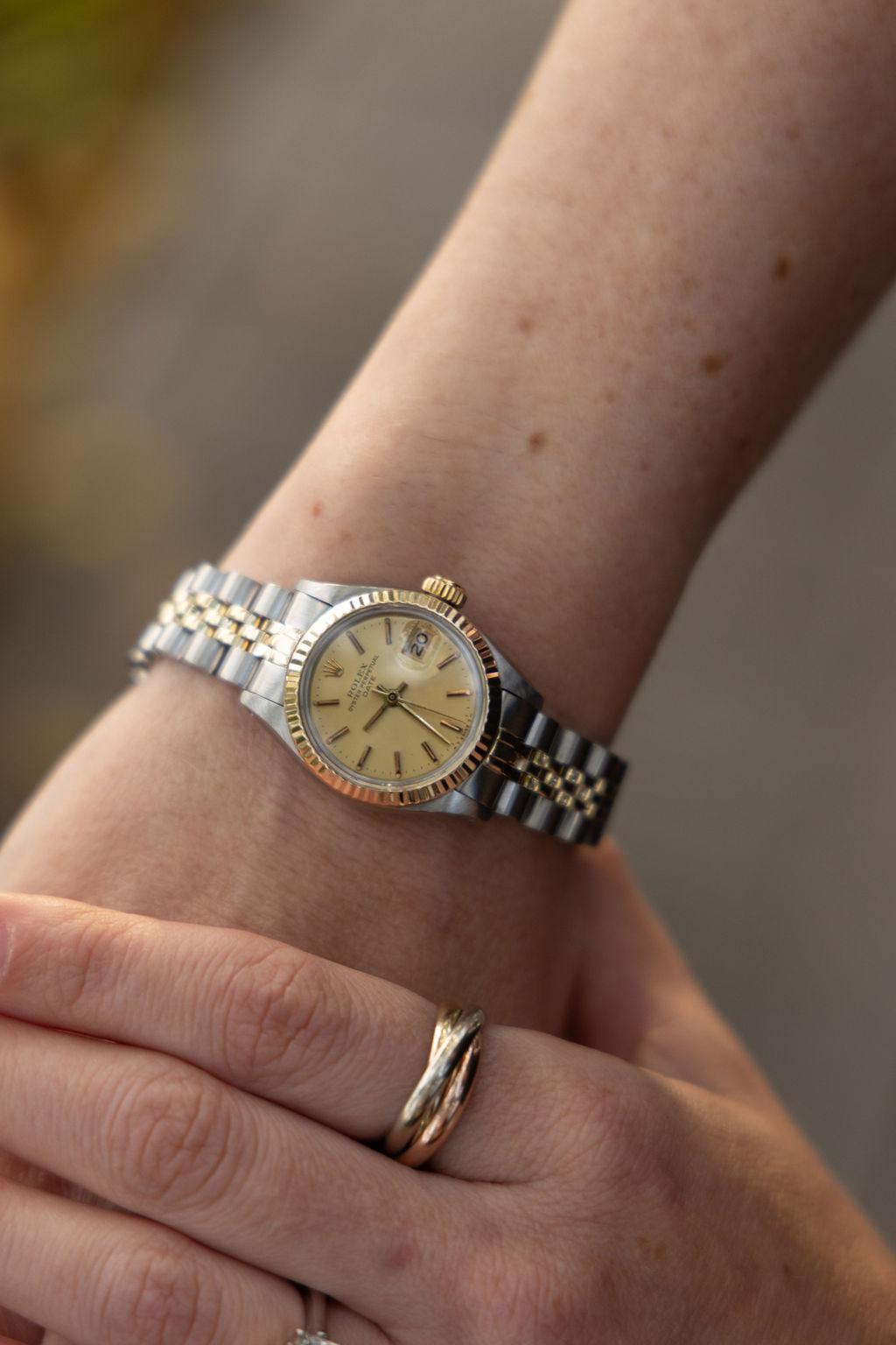 Pre-Owned Rolex Date Automatic Watch Crafted in 14 Karat Yellow Gold and Stainless Steel with Fluted Bezel, Champagne Dial, and Jubilee Bracelet. Model 6917,  Circa 1982. Overhauled and Polished January 2024. Includes One Year Timekeeping Warranty.