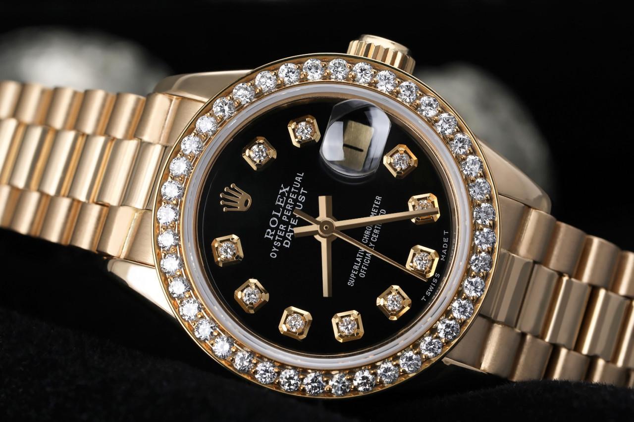 Rolex 26mm Datejust 18kt Gold Black Color Dial with Diamond Accent Diamond Bezel 6917

This watch is in like new condition. It has been polished, serviced and has no visible scratches or blemishes. All our watches come with a standard 1 year