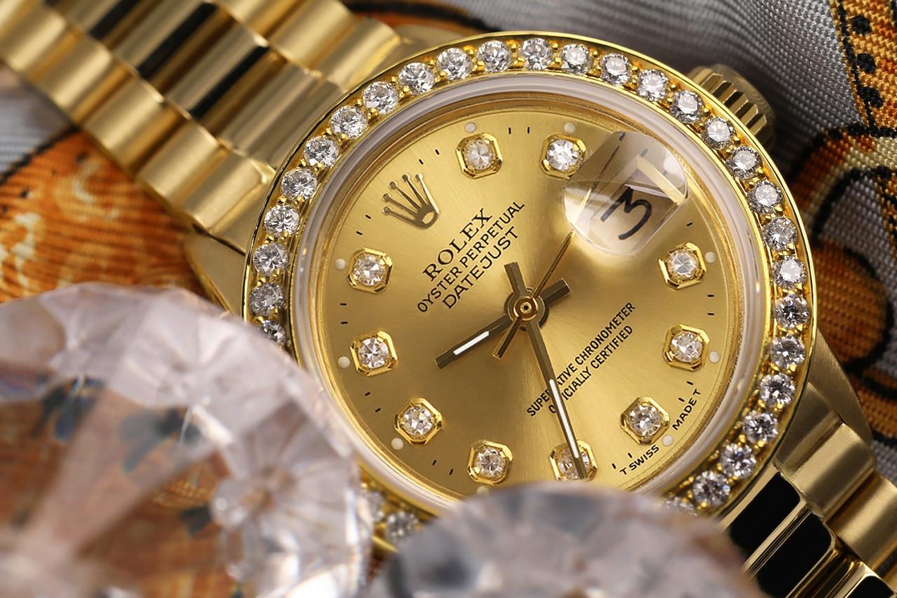 Rolex 26mm Datejust 18kt Gold Champagne Gold Diamond Dial Diamond Bezel 6917

This watch is in like new condition. It has been polished, serviced and has no visible scratches or blemishes. All our watches come with a standard 1 year mechanical