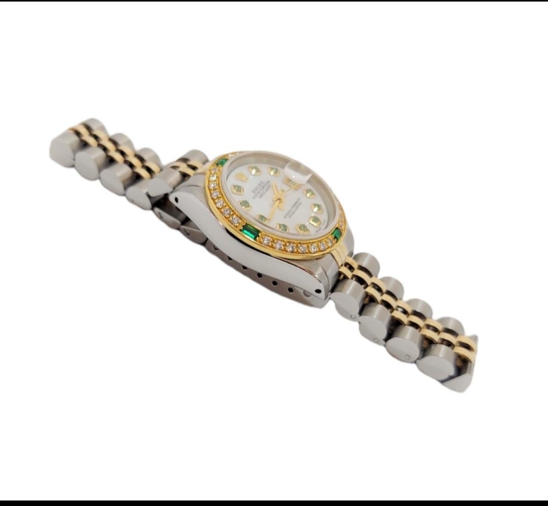 (Watch Description)
Brand - Rolex
Model - 6917 Datejust
Metals - Yellow Gold / Seel
Case size - 26, mm
Dial - White emerald
Bezel - Yellow gold emerald/diamond  
Crystal - Sapphire
Movement - Automatic CAL-2030
Wrist Band - Two tone Jubilee
Wrist