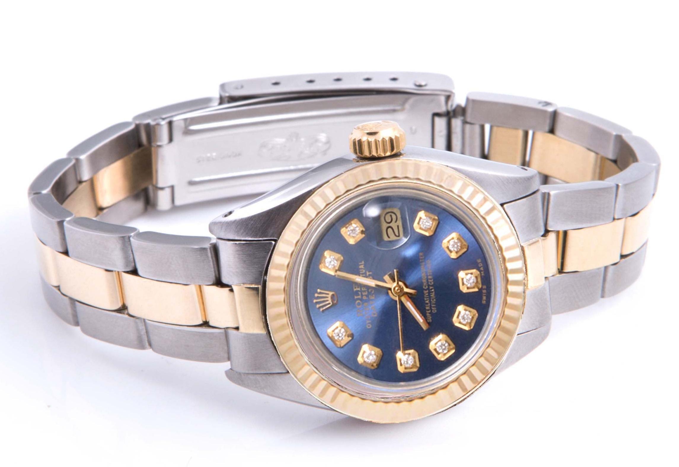(Watch Description) 
Brand - Rolex
Gender - Ladies
Model - 6917 Datejust
Metals - Yellow gold / steel
Case size - 26mm
Bezel - Yellow Gold Fluted
Crystal - Acrylic
Movement - Automatic Cal.2035
Dial - Custom Blue Diamond
Wrist band - Rolex Two-tone