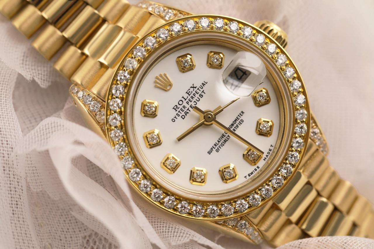 Rolex 26mm Presidential 18kt Gold White Diamond Dial Bezel and Lugs 6917

This watch is in like new condition. It has been polished, serviced and has no visible scratches or blemishes. All our watches come with a standard 1 year mechanical warranty