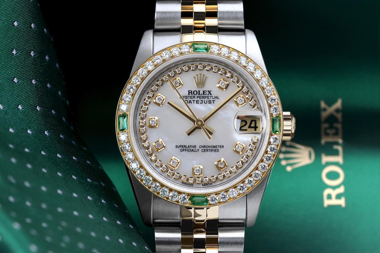 Women's Rolex 31mm Datejust Vintage Diamond Bezel with Emeralds Two Tone White MOP String Dial with Diamond Accent 68274

This watch is in like new condition. It has been polished, serviced and has no visible scratches or blemishes. All our watches