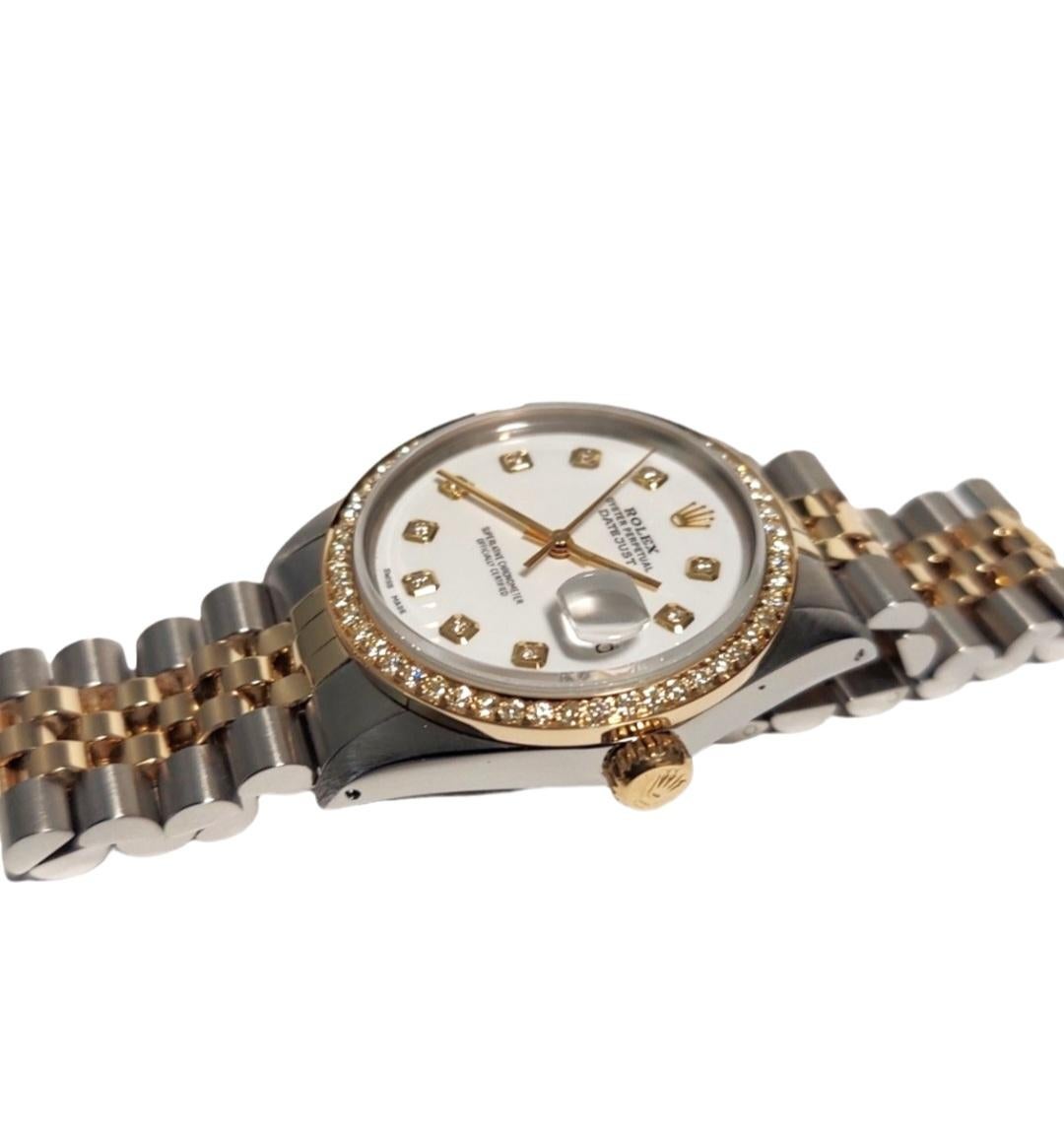 Brand - Rolex
Gender - Unisex
Style - Datejust
Model - 16013 
Metals - Yellow Gold/ Steel
Case size - 36mm
Dial - Custom White Dial
Bezel - Custom Yellow Gold Diamond
Crystal - Sapphire 
Movement - Auto Cal-3035
Band - Rolex Two-tone Jubilee