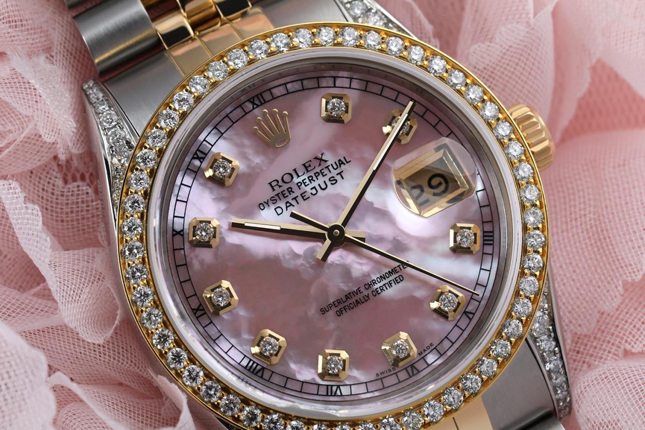 Rolex 36mm Datejust Pink Mother Of Pearl Dial with Diamond Markers Diamond Bezel & Lugs 16013.
This watch is in like new condition. It has been polished, serviced and has no visible scratches or blemishes. All our watches come with a standard 1 year