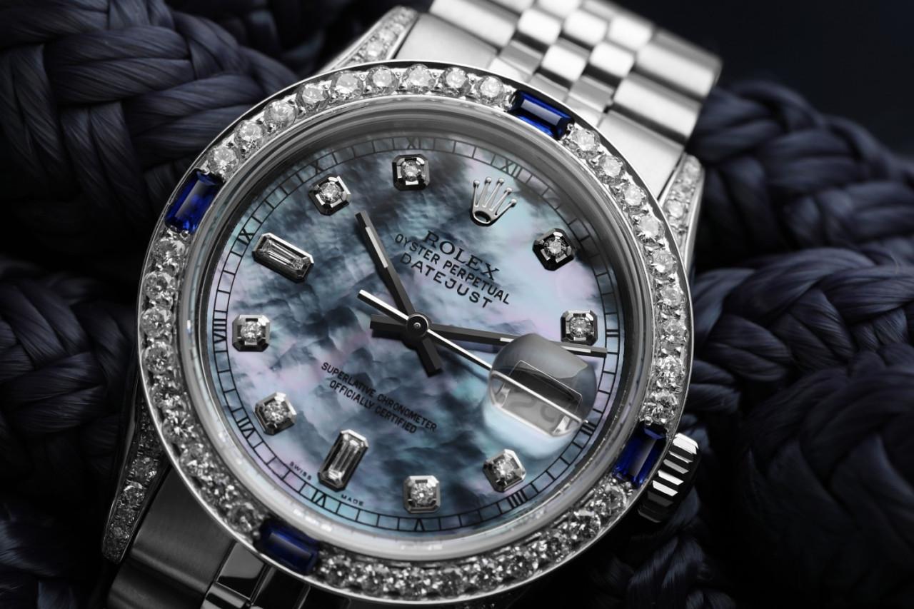 Rolex 36mm Datejust 16014 Tahitian Mother of Pearl Diamond Dial with Sapphire & Diamond Bezel Jubilee Band.
This watch is in like new condition. It has been polished, serviced and has no visible scratches or blemishes. All our watches come with a