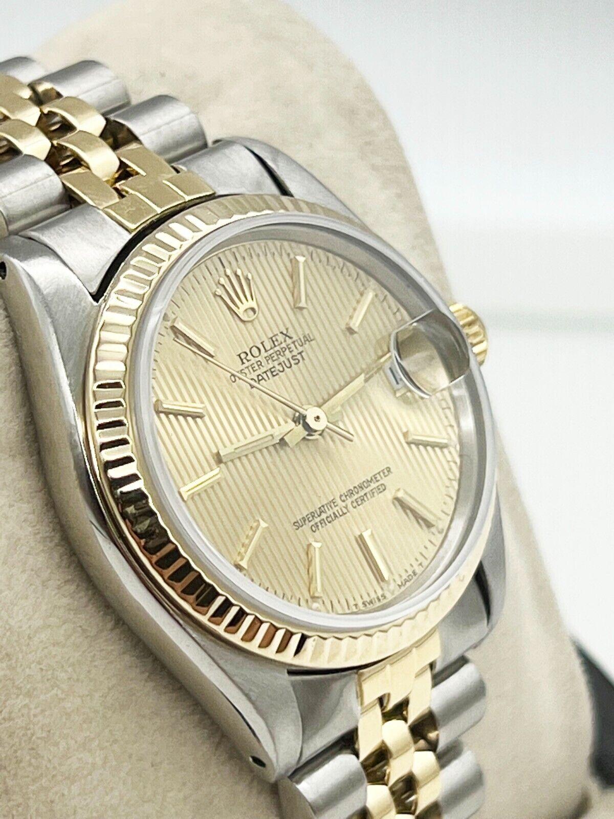Style Number: 6827
Serial: 7389***
Year: 1982
Model: Midsize Datejust 
Case Material: Stainless Steel 
Band: 18K Yellow Gold & Stainless Steel 
Bezel: 18K Yellow Gold 
Dial: Champagne Tapestry Dial 
Face: Sapphire Crystal 
Case Size: 31mm