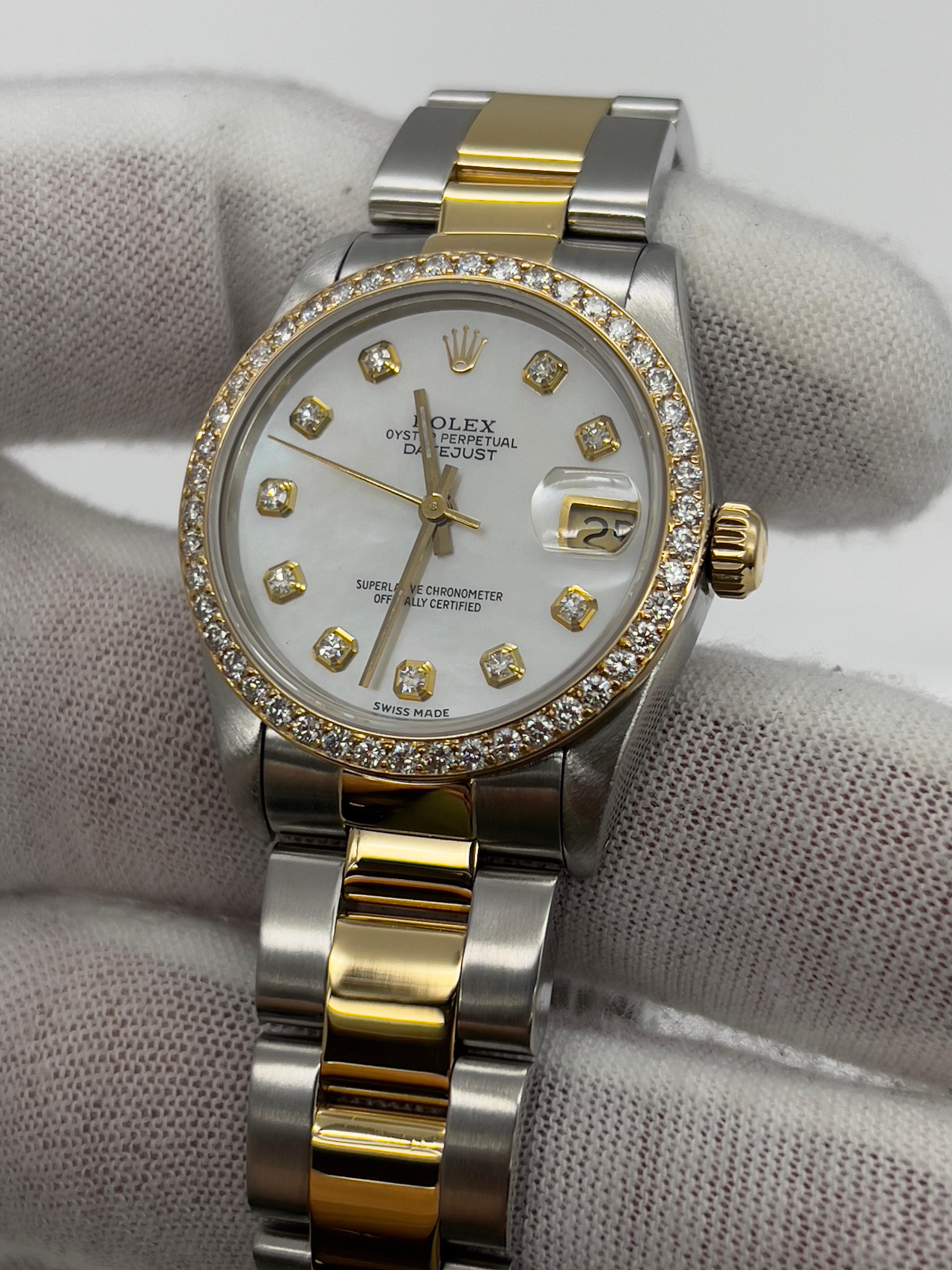 Style Number: 68273
Serial: 8899***
Year: 1985
Model: Rolex Midsize Datejust
Case Material: 18K Yellow Gold & Stainless Steel 
Band: 18K Yellow Gold & Stainless Steel 
Bezel: Custom Diamond Bezel 
Dial: Custom Mother Of Pearl Diamond Dial 
Face: