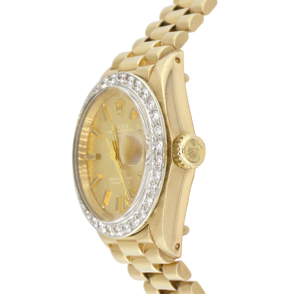 Brand: Rolex
MPN: 6917
Model: Datejust
Case Material: 18k Yellow Gold
Case Diameter: 26mm
Crystal: Plastic Crystal
Bezel: Round diamond bezel (aftermarket)
Dial: Champagne dial with yellow gold stick hour markers. Date can be found at 3