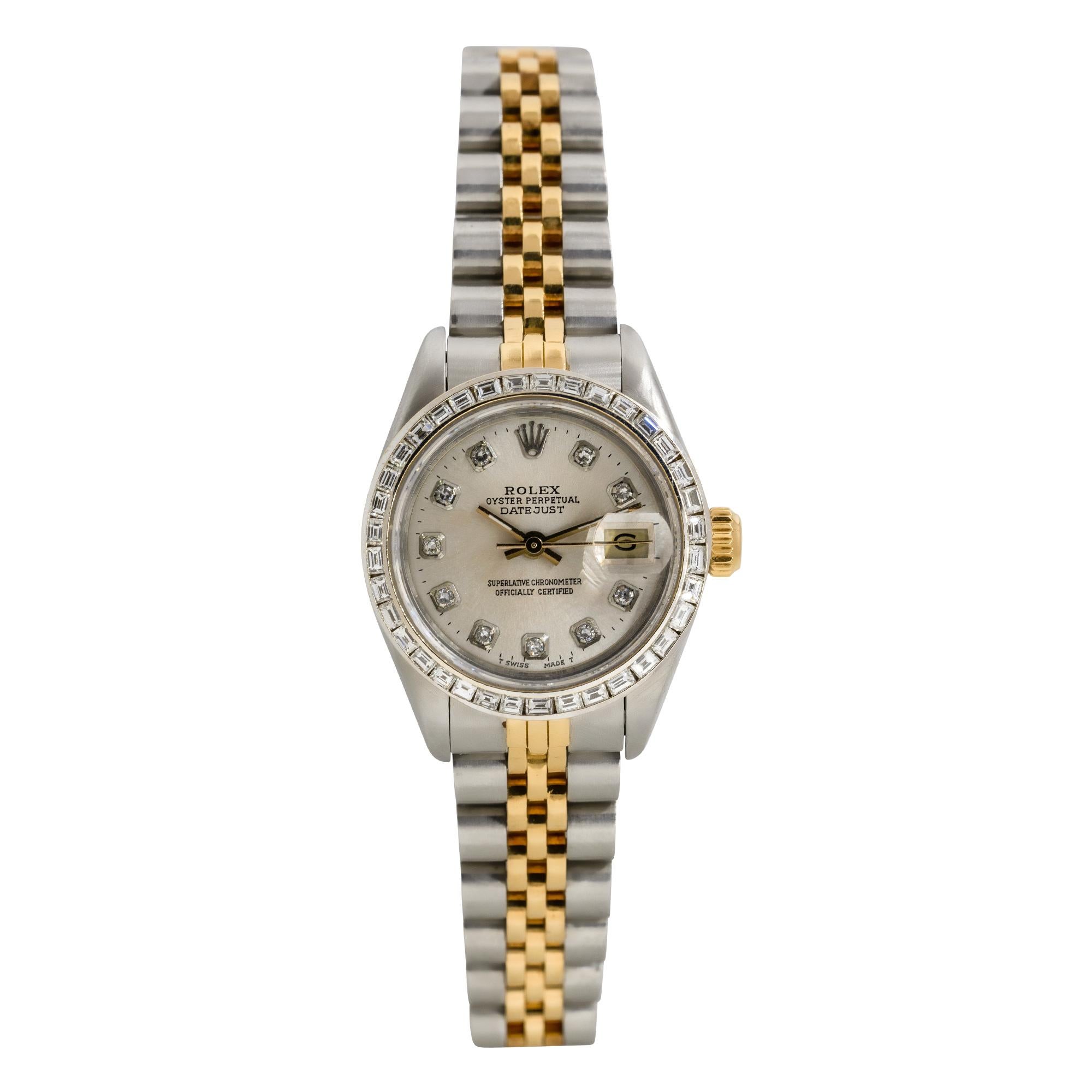 Brand: Rolex
MPN: 69173
Model: Datejust
Case Material: Stainless steel
Case Diameter: 26mm
Crystal: Sapphire Crystal
Bezel: Aftermarket 18k white gold bezel with baguette cut Diamonds
Dial: Aftermarket silver dial with Diamond hour markers. Date can