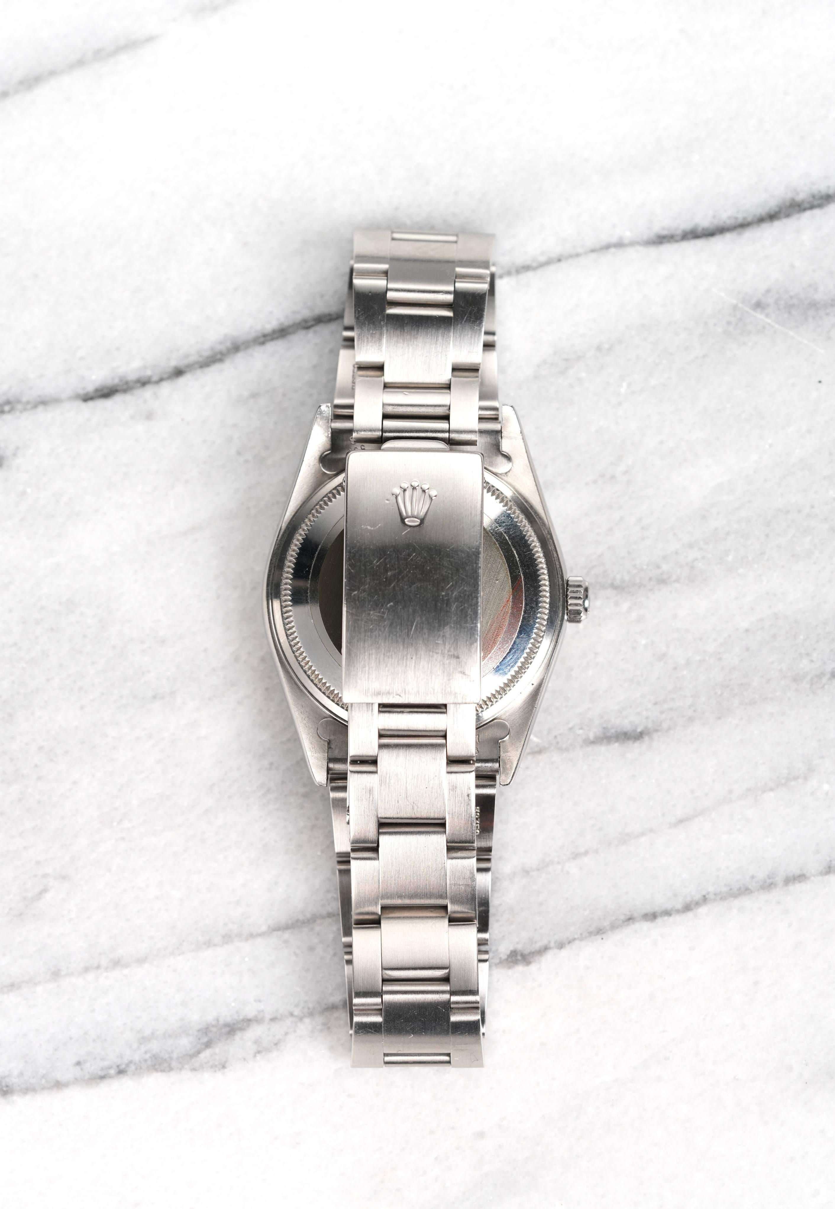 Here’s a Rolex Air-King Oyster Perpetual, reference number 14000, automatic with a silver sunburst dial from the 1990s. Keeps excellent time and is fully functional. This piece features a 34mm stainless steel Oyster case with a 19mm lug width,