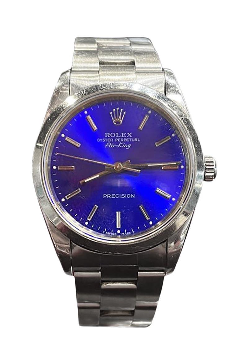 Brand: Rolex

Model Number: 14000A

Movement: Automatic

Case Size: 34 mm

Case Back: Solid

Case Material: Stainless Steel 

Bezel: Smooth

Dial: Electric Blue

Bracelet:  Stainless Steel; Oyster 

Hour Markers: Stick

Features: Hours, Minutes,