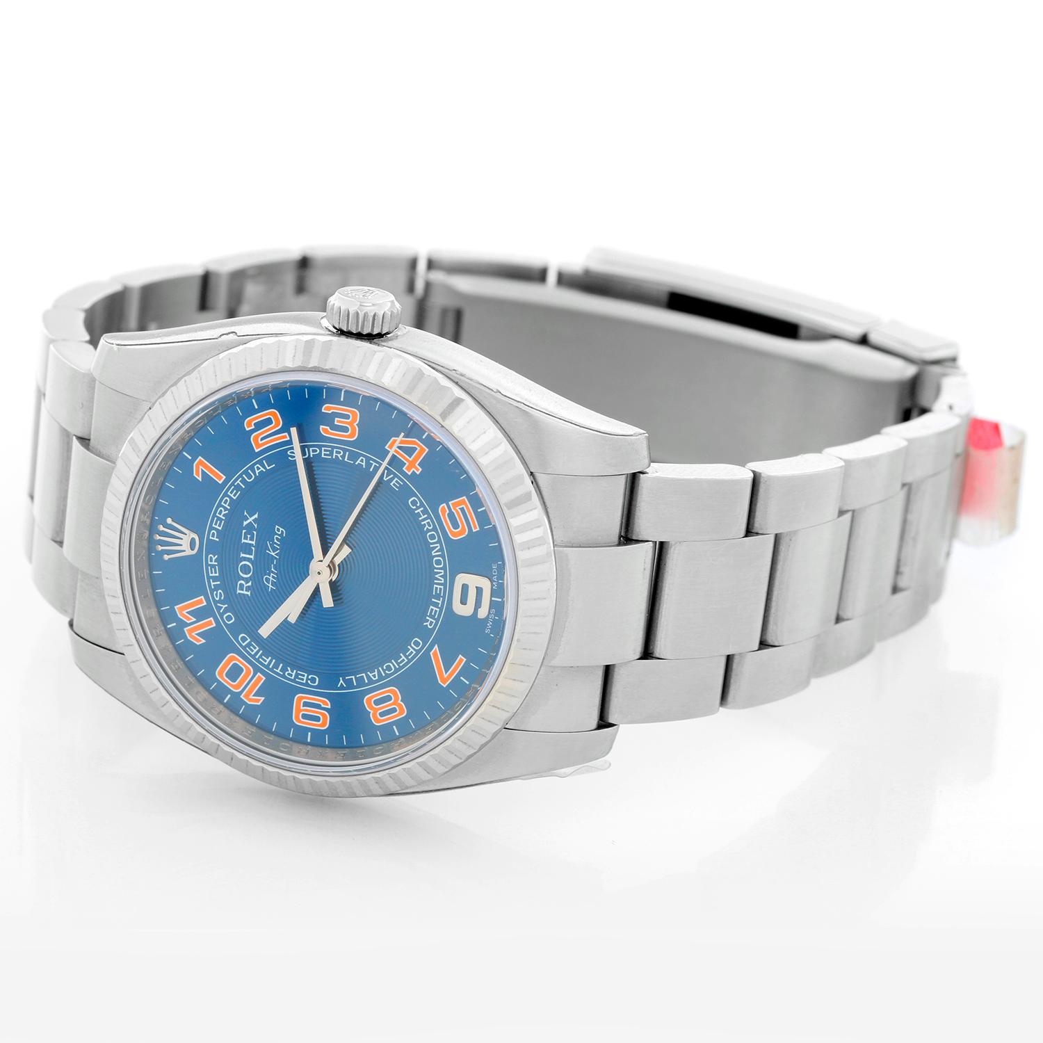 Rolex Air-King Men's Stainless Steel Blue Dial Watch  114234 - Automatic winding, 31 jewels, no-date, sapphire crystal. Stainless steel case with 18k white gold bezel (33mm diameter). Blue concentric dial with orange Arabic numerals . Stainless