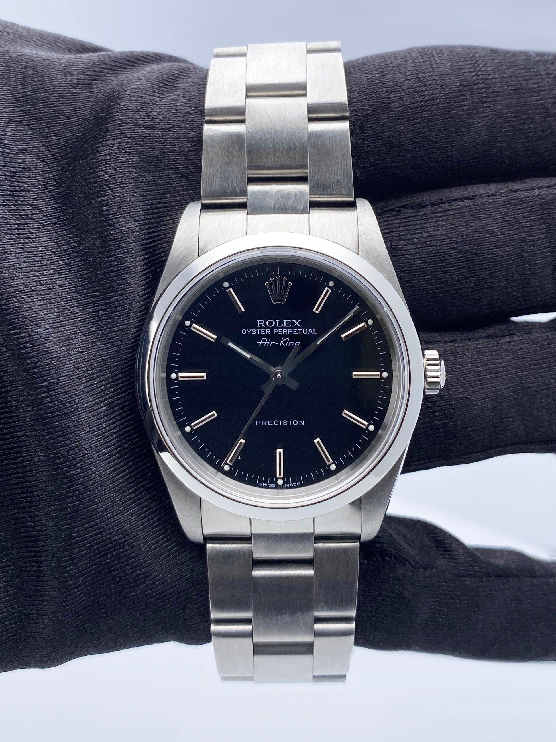 Rolex Air-King Precision 14000M Mens Watch. 34mm stainless steel case. Stainless steel smooth bezel. Black dial with luminous steel hands and index hour markers. Minute markers on the outer dial. Stainless steel Oyster bracelet with stainless steel