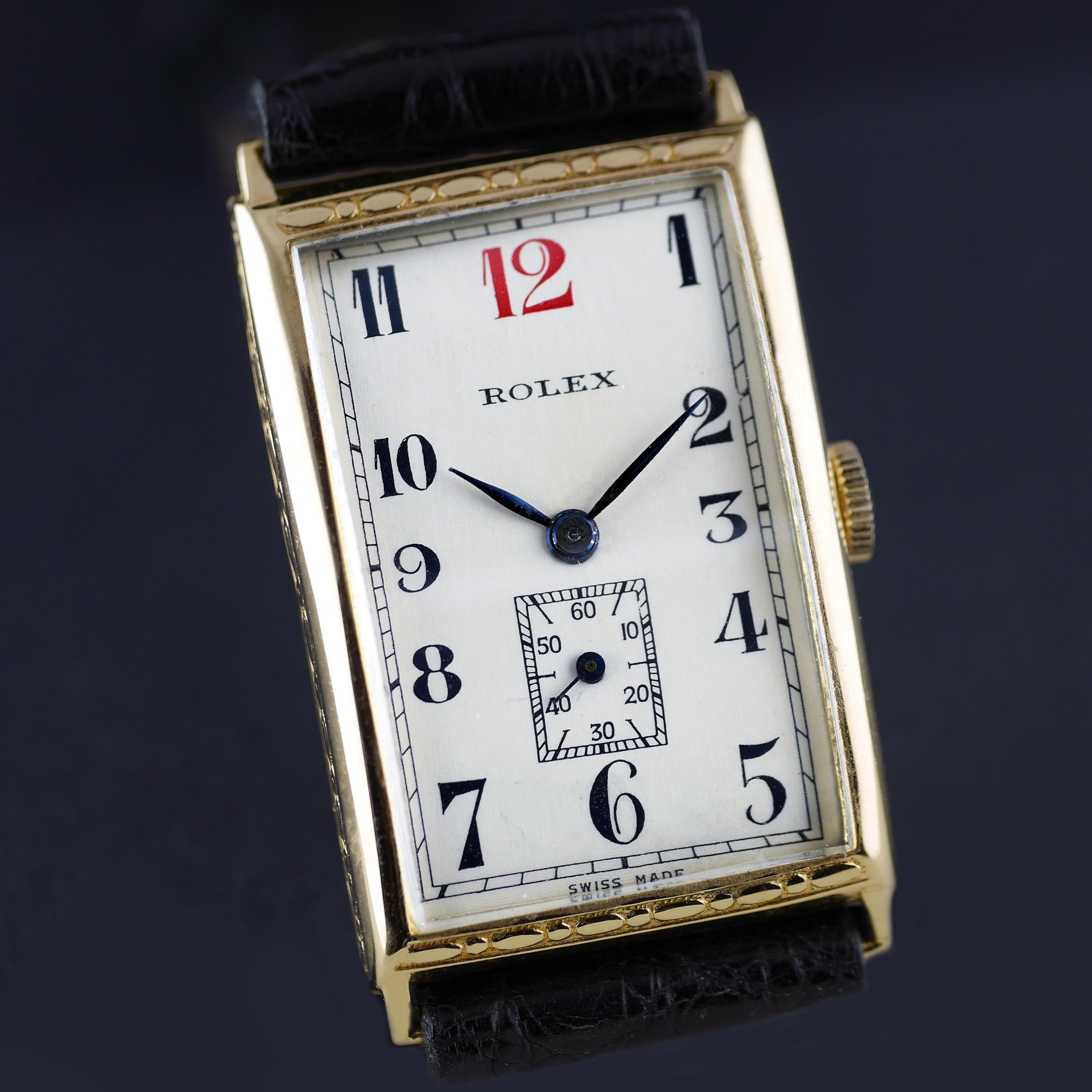 An Art Deco vintage wristwatch by Rolex dated 1927. This unusual and rare rectangular shaped Rolex wristwatch, with a distinctive red 12 and hand chased (engraved) case detailing, was made in the height of the Art Deco era. This is a very high grade