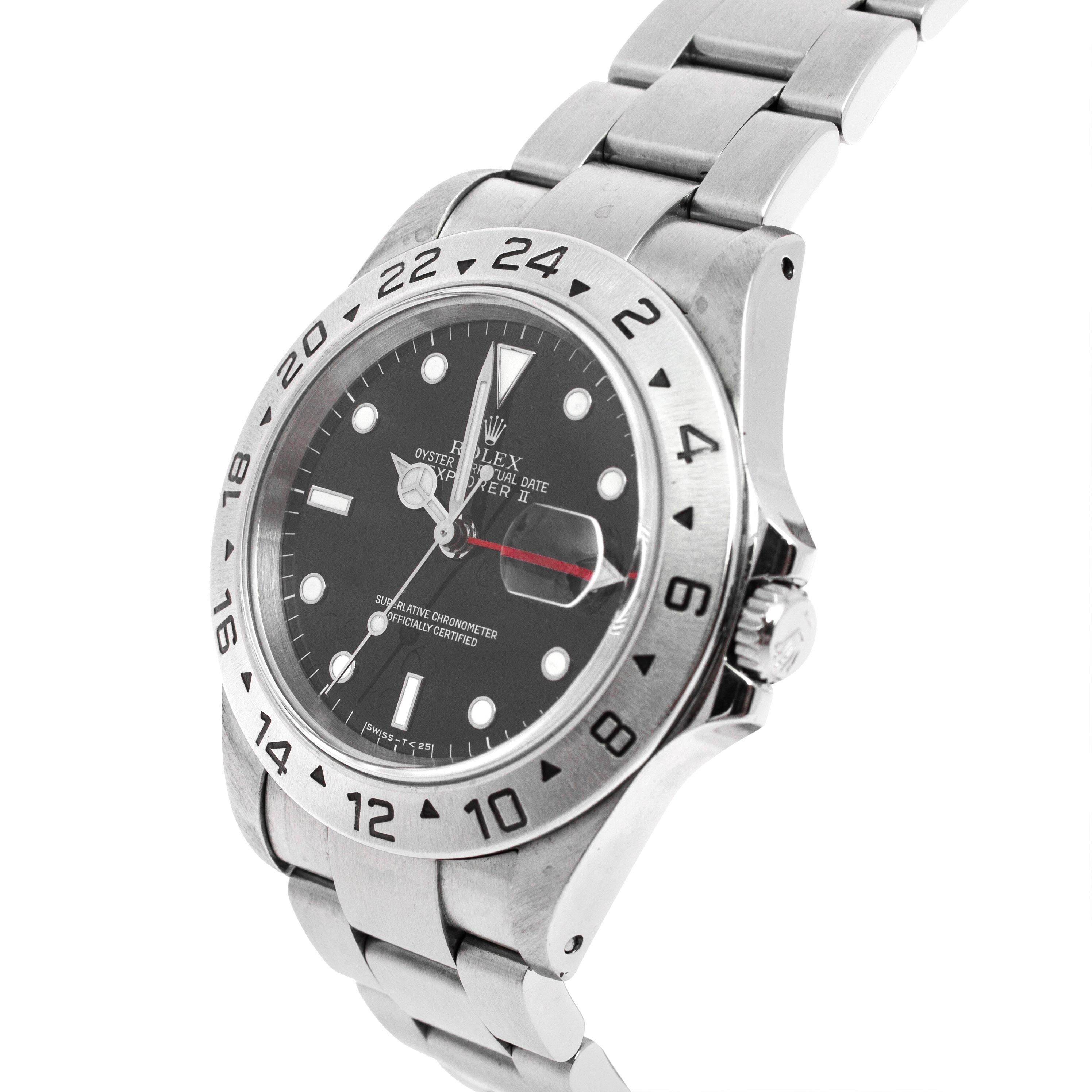 The Explorer II by Rolex has a distinctive black dia set with chromalight hour markers, hands for hours, minutes, and seconds, a date window, and a dedicated arrow-shaped hand that circles in 24 hours rather than 12. The bezel is detailed with