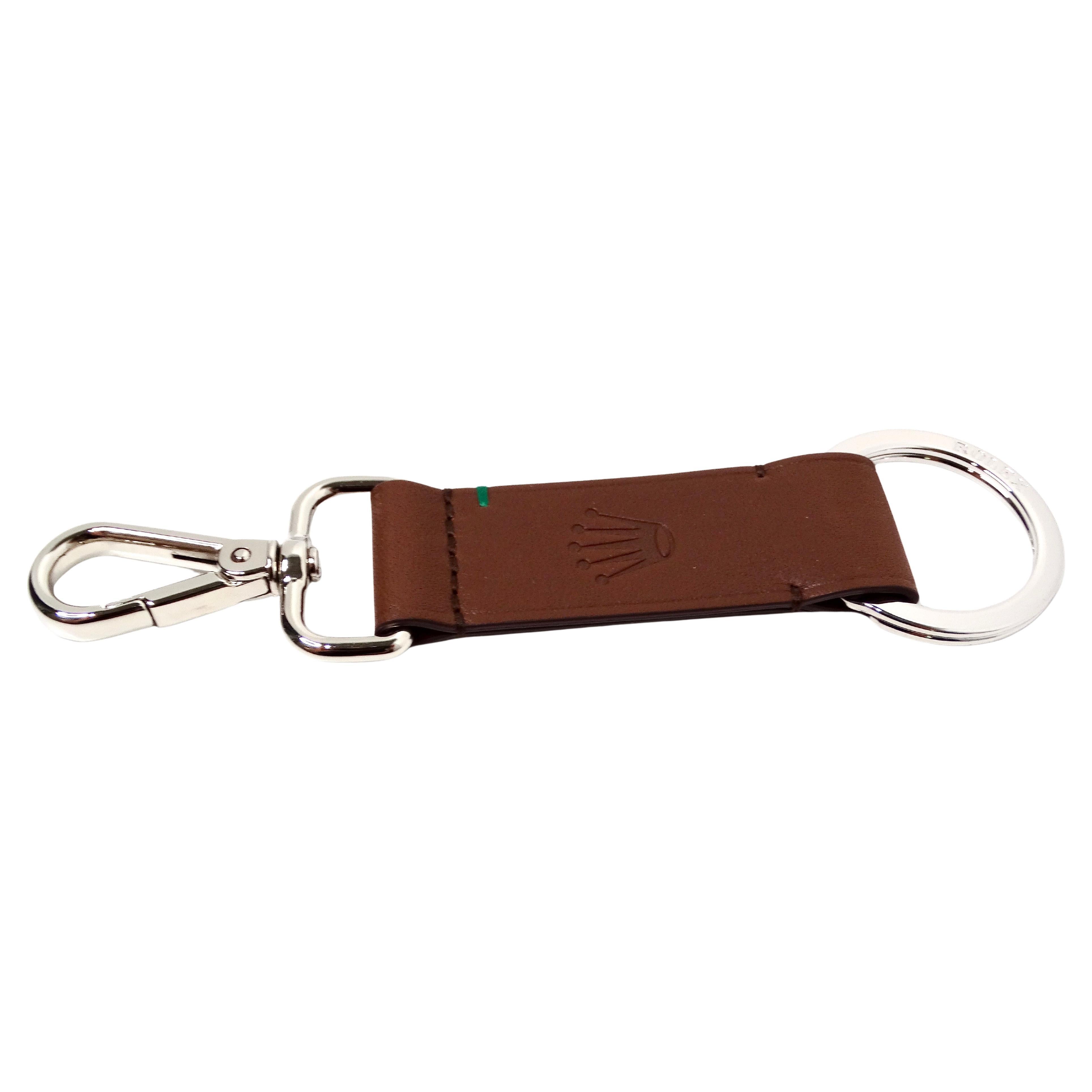 The Rolex Brown Leather Crown Logo Embossed Keychain is a sophisticated accessory that exemplifies understated luxury and timeless elegance. Crafted from high-quality brown leather, it features a meticulously embossed Rolex crown logo, symbolizing