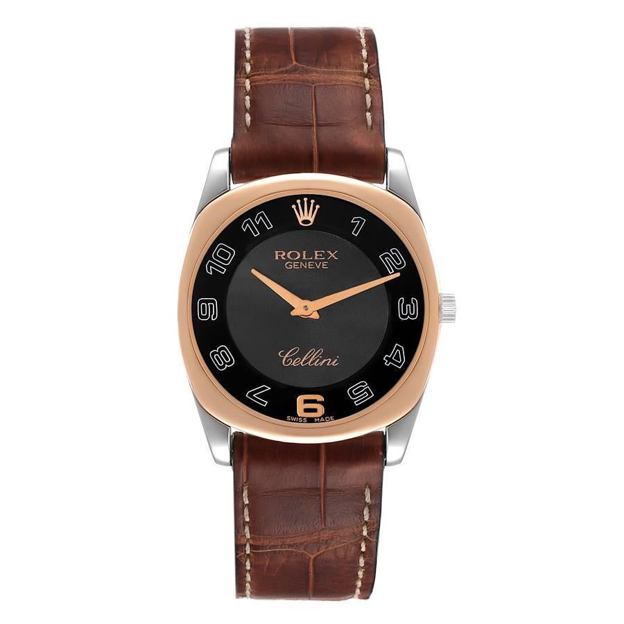 Rolex Cellini Danaos White and Rose Gold Brown Strap Mens Watch 4233. Manual winding movement. 18k white and rose gold rounded rectangular case 34.0 mm. Rolex logo on a crown. . Scratch resistant sapphire crystal. Black dial with oversized arabic