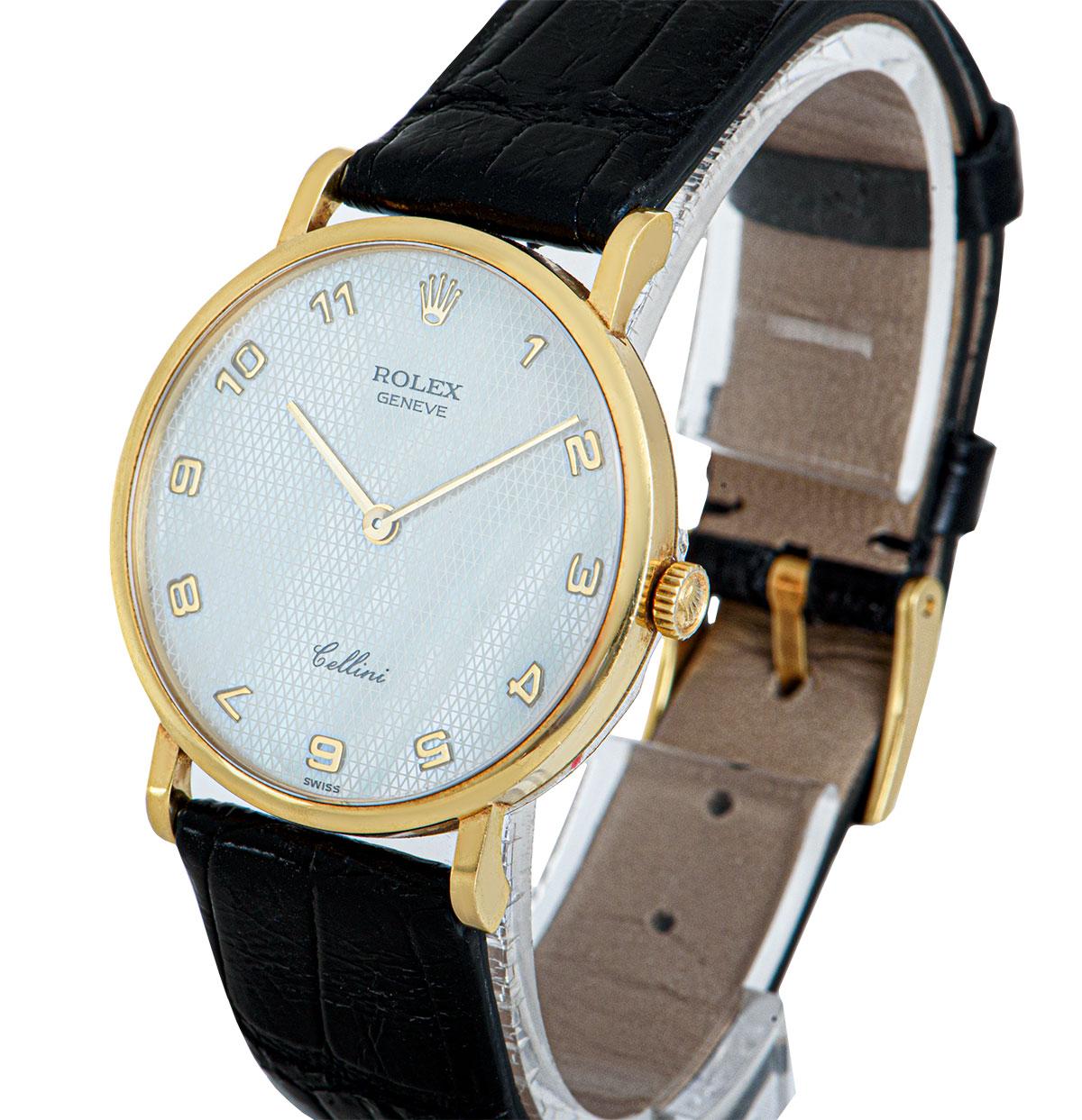A 32 mm 18k Yellow Gold Cellini Gents Wristwatch, white mother of pearl dial with applied arabic numbers, a fixed 18k yellow gold bezel, a black leather strap (not by Rolex) with an original 18k yellow gold pin buckle, sapphire glass, manual wind