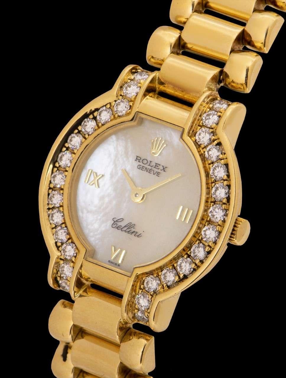 An 18k Yellow Gold Cellini Ladies Wristwatch, white mother of pearl dial with applied roman numerals, a fixed 18k yellow gold bezel set with 28 round brilliant cut diamonds, an 18k yellow gold bracelet with a concealed 18k gold deployant clasp,