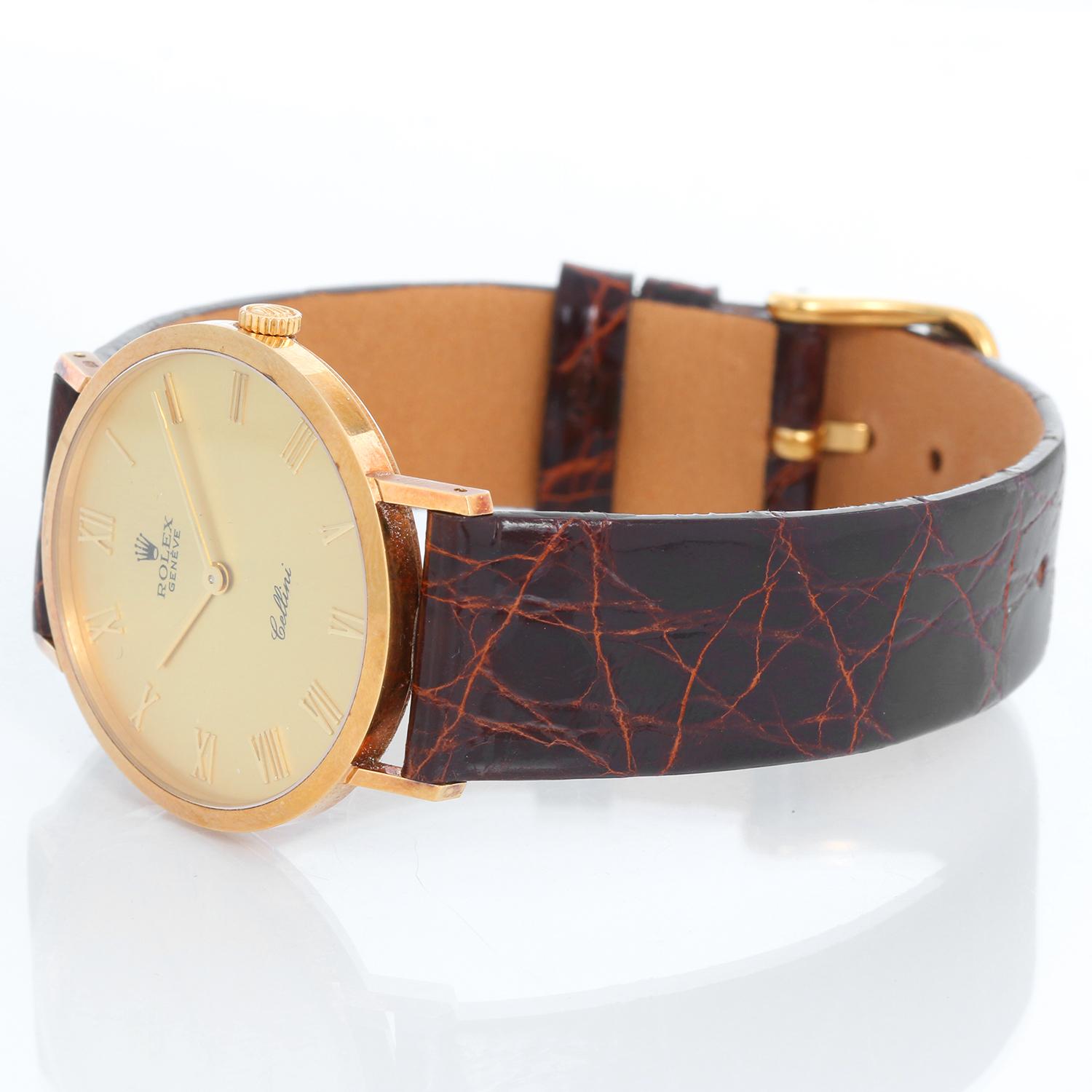 Rolex Cellini Men's 18k Yellow Gold Watch on Strap Band Mod. 4112 - Manual winding. 18k yellow gold case (32mm diameter). Champagne dial with Roman numerals. Brown strap with tang buckle. Pre-owned with custom box and papers.