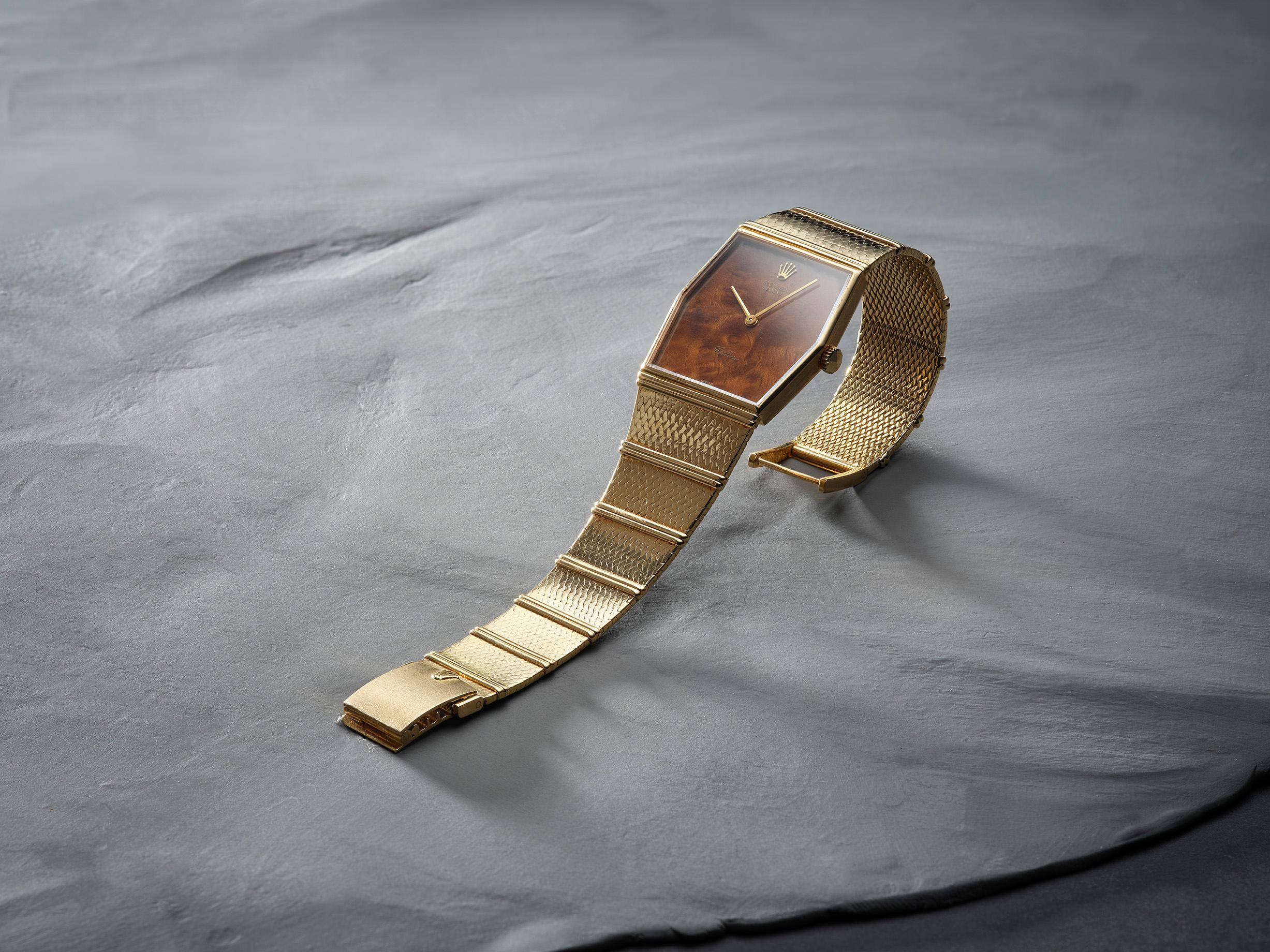 This exceptional Rolex Cellini Reference 4324 epitomizes refined elegance with its distinctive hexagonal 18k yellow gold case and integrated woven bracelet. The standout feature is its lacquered walnut wood dial, offering a unique aesthetic that