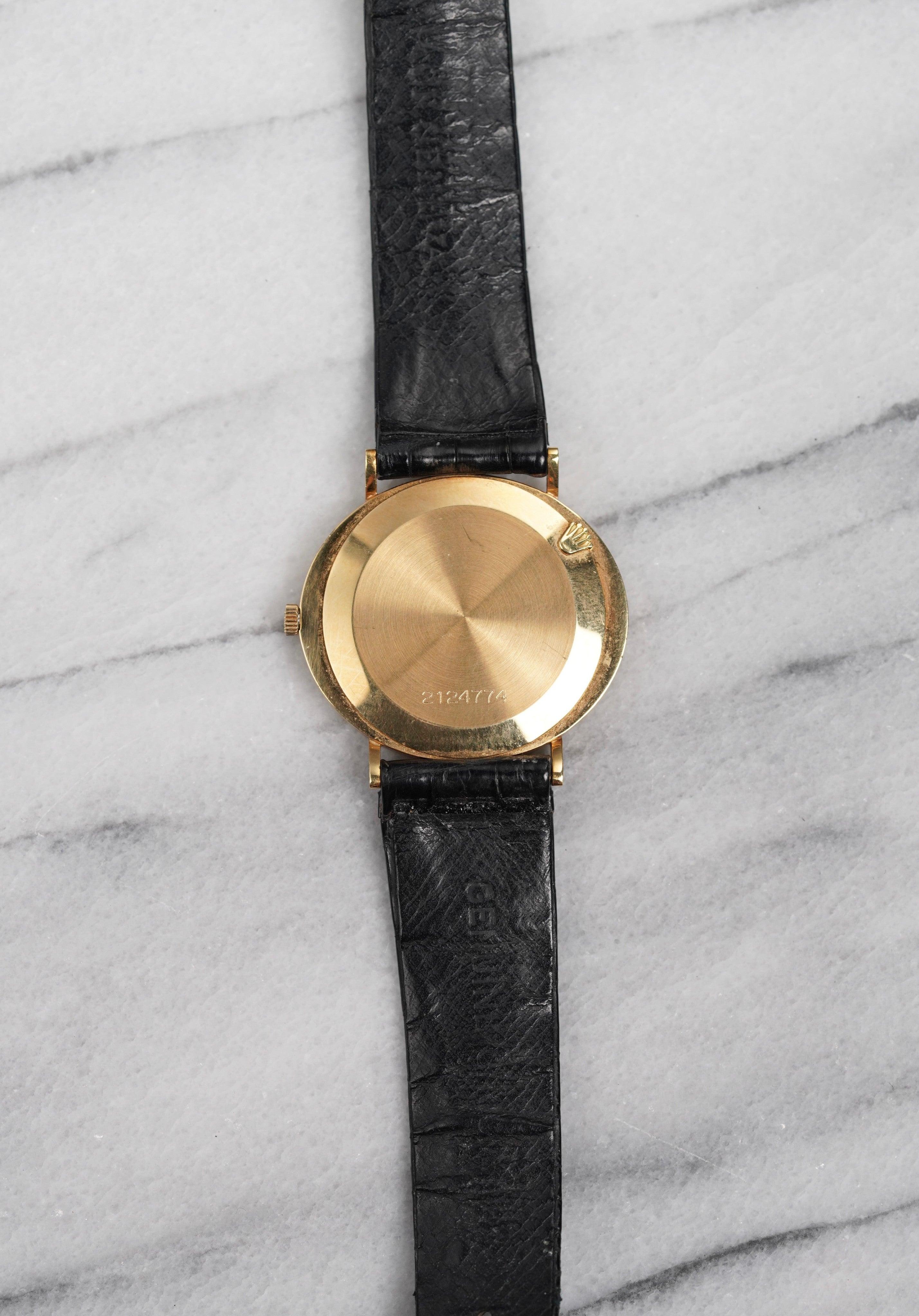 Here's a vintage Rolex Cellini manual wind in 18K yellow gold with a champagne sunburst dial from the 80s. Keeps great time and is fully functional. Measurements include a 32mm case size and 18mm lug width. On its original black leather strap and