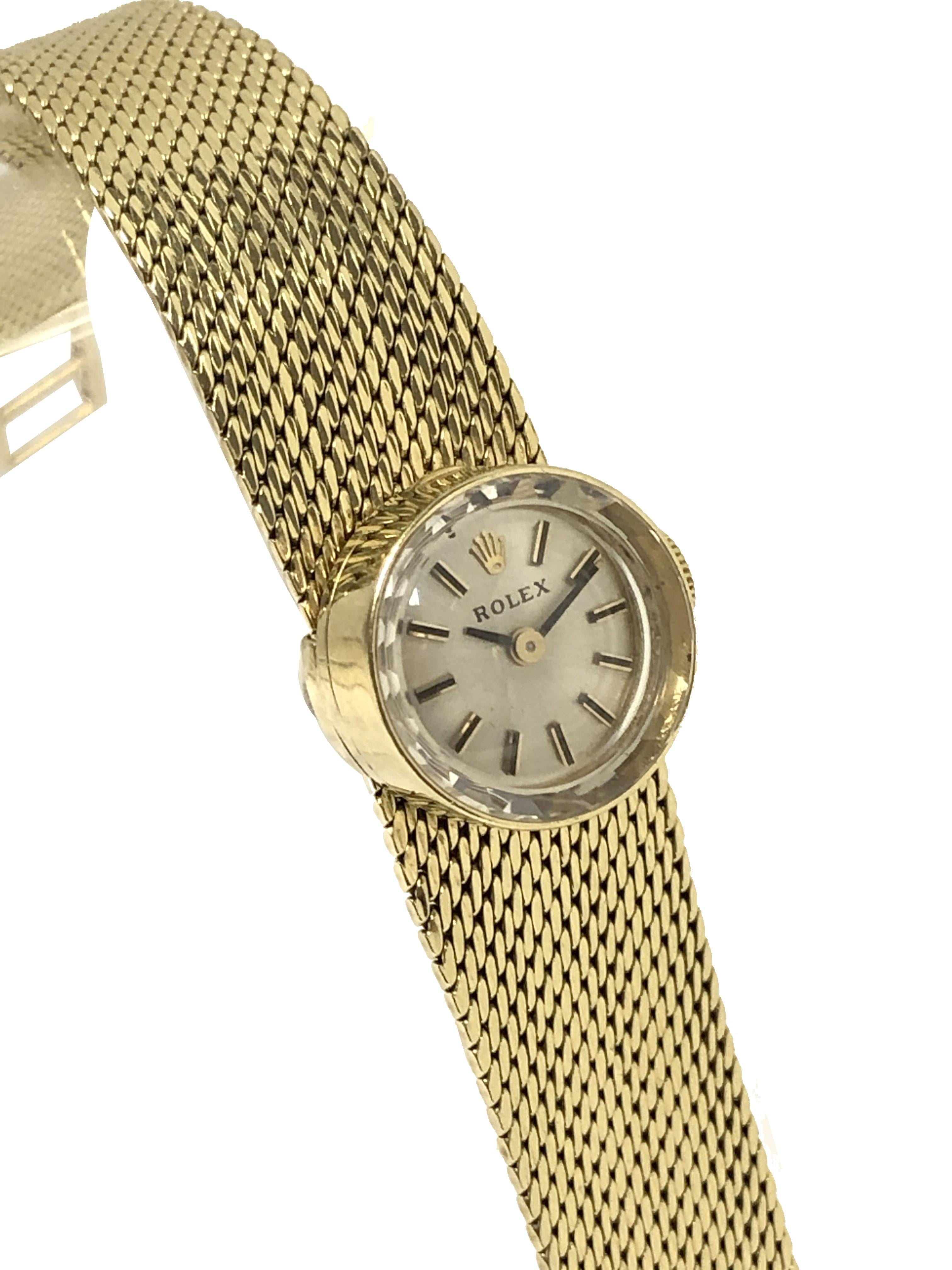 Circa 1960 Rolex Chameleon Ladies Wrist Watch, This unique Watch is on a 14k Yellow Gold soft woven style bracelet that is removable to be interchanged with 7 different color Leather and Fabric straps, each with a Yellow Gold filled Rolex buckle and