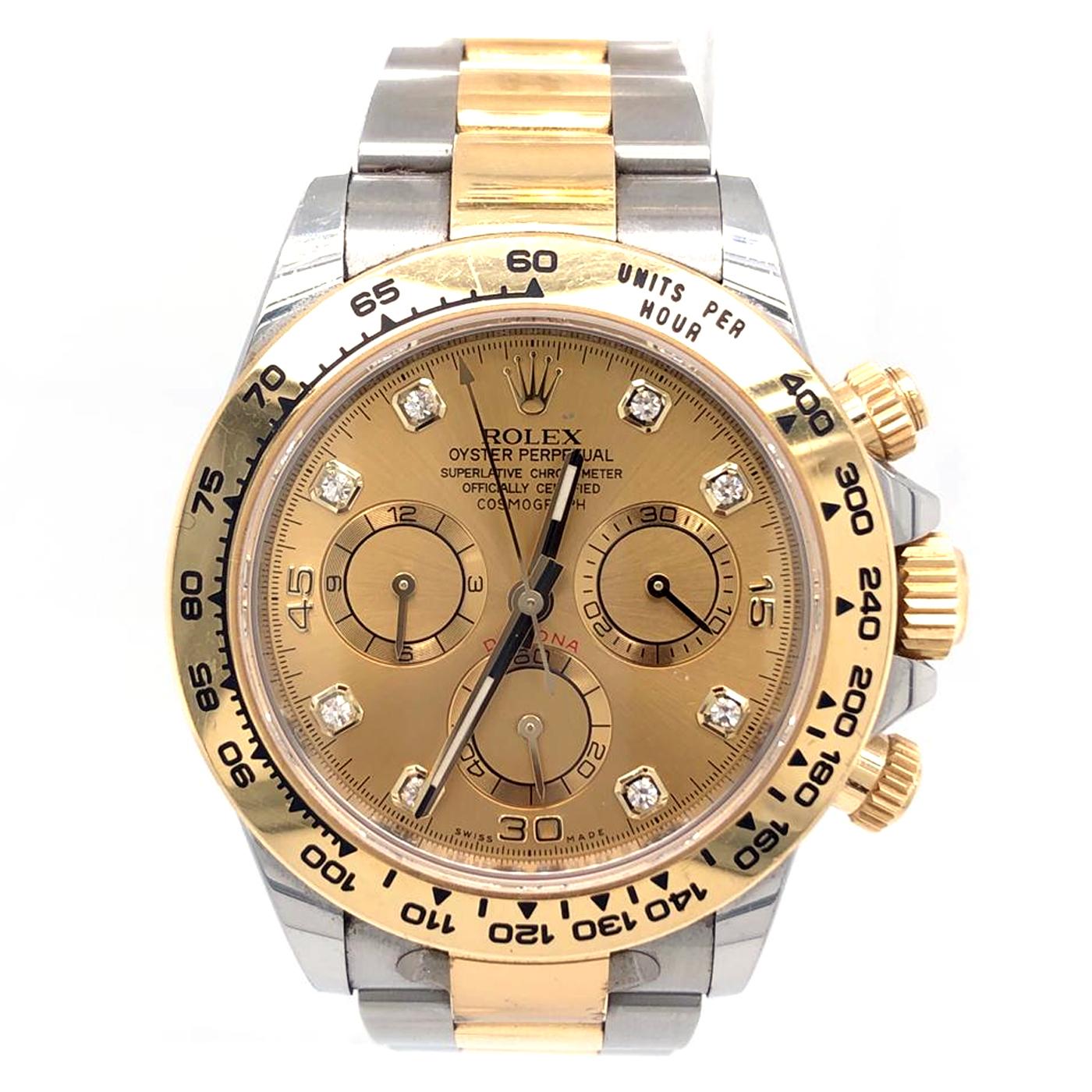 Silver-tone stainless steel case with a two-tone (silver-tone and gold-tone) stainless steel and 18kt yellow gold Rolex oyster bracelet. Fixed tachymeter scale 18kt yellow gold bezel. Champagne dial with gold-tone hands and diamond hour markers.
