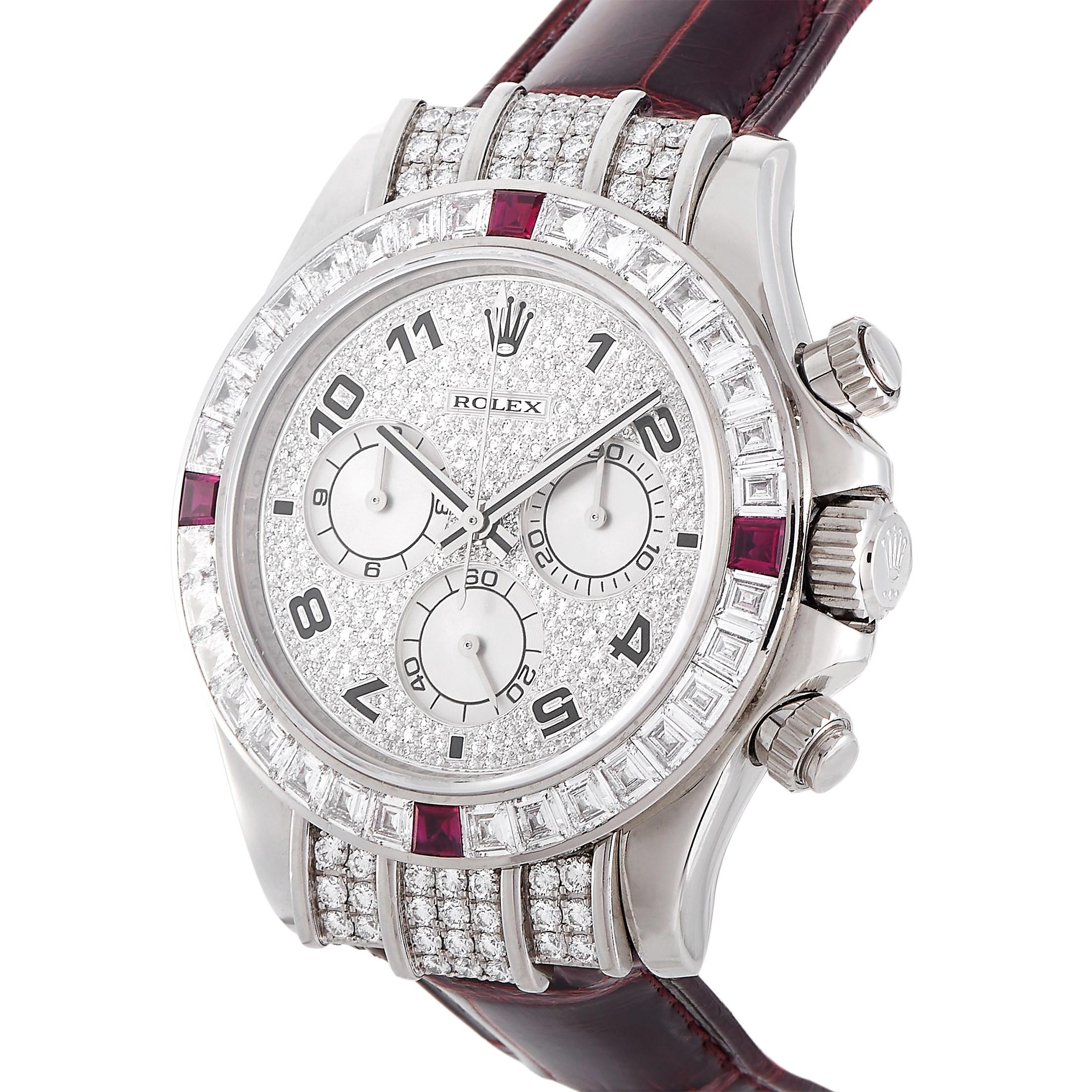 This is a fine and rare Rolex Cosmograph Daytona, reference number 116599.

The watch boasts a diamond-embellished 18K white gold case that measures 39 mm in diameter. The case is fitted with a bezel set with baguette-cut diamonds and four rubies.