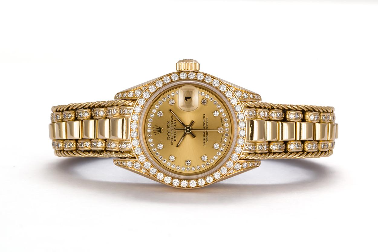We are pleased to offer this Rare 1993 Rolex Crown Collection Ladies Datejust President 69238. This very rare version of the classic Rolex ladies 26mm watch features a solid 18k Yellow gold case with factory diamond lugs, factory diamond bezel and a