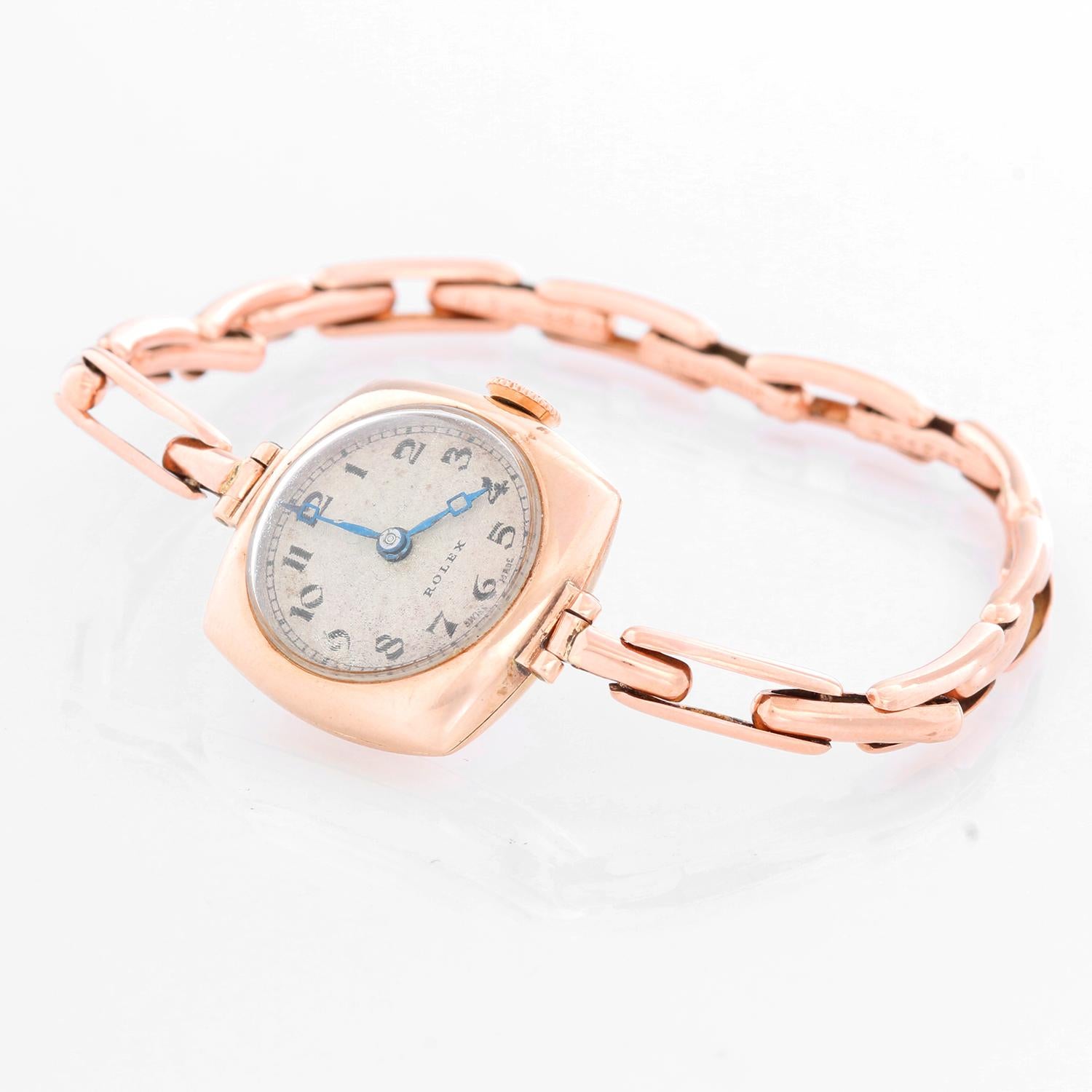 Rolex Cushion Shaped Oyster Rose Gold Watch - Manual winding. Rose gold ( 20 x 20 mm ). Ivory Guilloche dial with Arabic numerals and blue Breguet hands. Rose gold link stretchy bracelet; will fit up to a 7 1/4 inch wrist. Pre-owned with custom box.