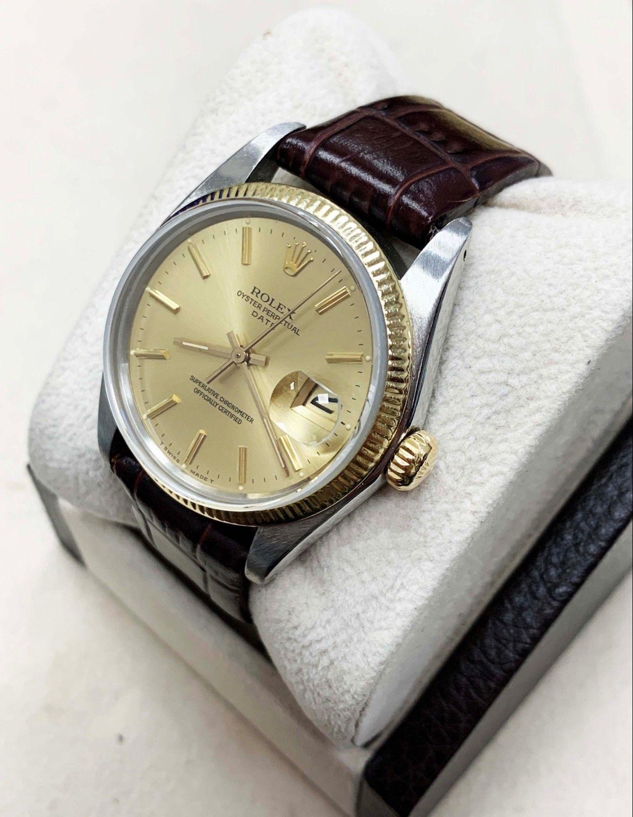 Style Number: 1500
Serial: 5446***
Model: Date
Case Material: Stainless Steel
Band: Custom Leather Band
Bezel: 14K Yellow Gold
Dial: Champagne
Face: Sapphire Crystal 
Case Size: 34mm
Includes: 
-Elegant Watch Box
-Certified Appraisal 
-6 Month