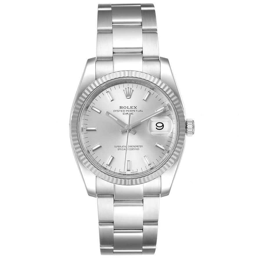 Rolex Date 34 Steel White Gold Silver Dial Mens Watch 115234 Unworn. Officially certified chronometer self-winding movement with quickset date. Stainless steel case 34 mm in diameter. High polished lugs. Rolex logo on a crown. 18K white gold fluted