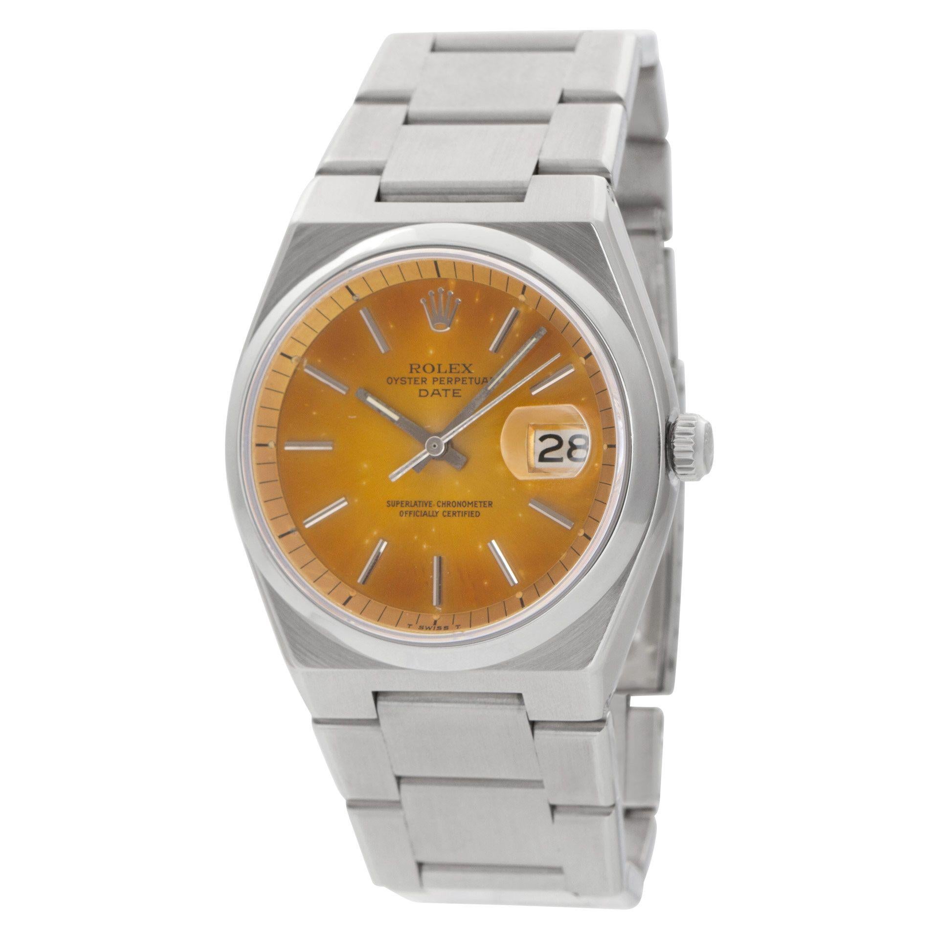 This extremely rare Rolex Date, model number 1530, is crafted in stainless steel and features a unique silver dial that has developed a tropical, or champagne hue, due to sun exposure. The watch is equipped with the first generation bracelet, which