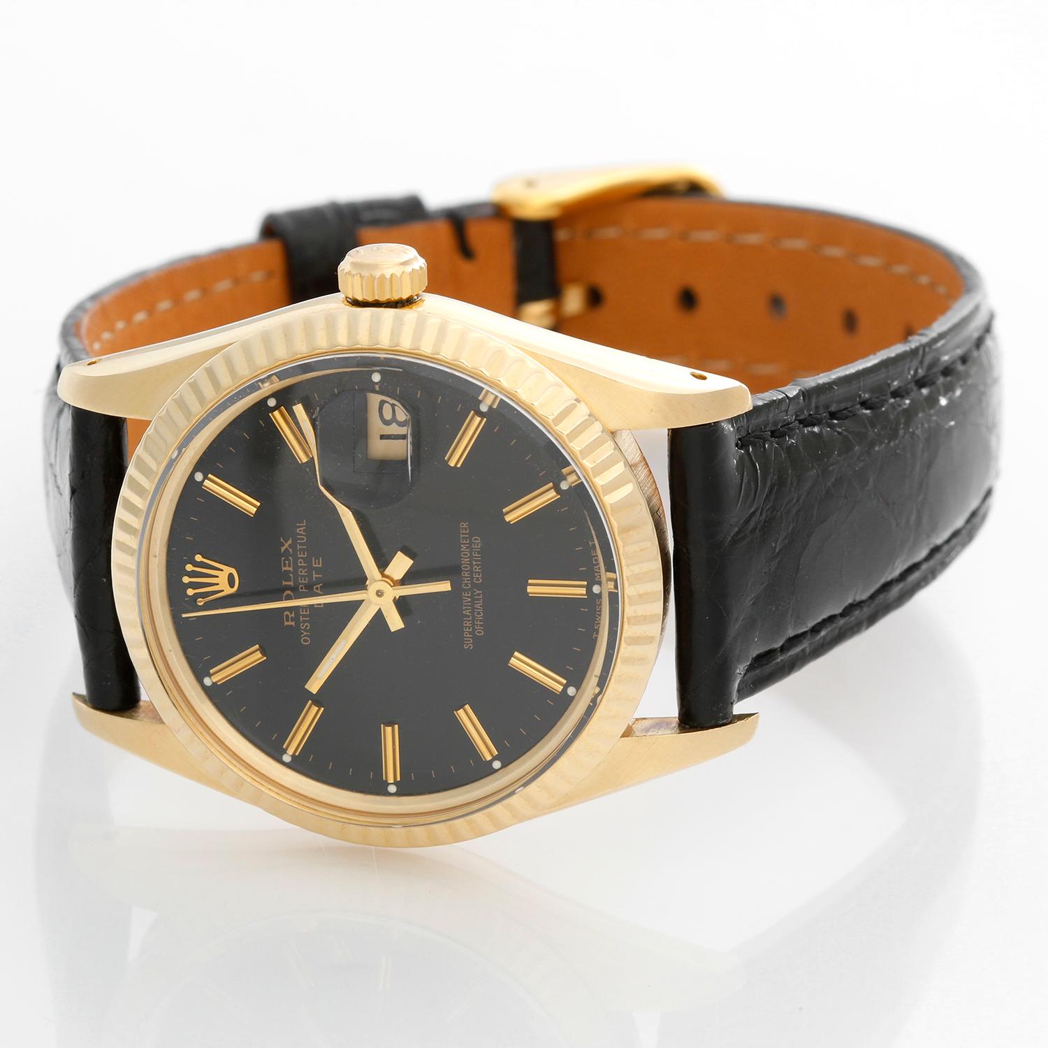 Rolex Date Men's 14k Yellow Gold Watch 15037 - Automatic winding. 14k yellow gold (34mm diameter). Black dial with yellow gold stick hour markers. Black leather strap with tang buckle. Pre-owned with Rolex box .
