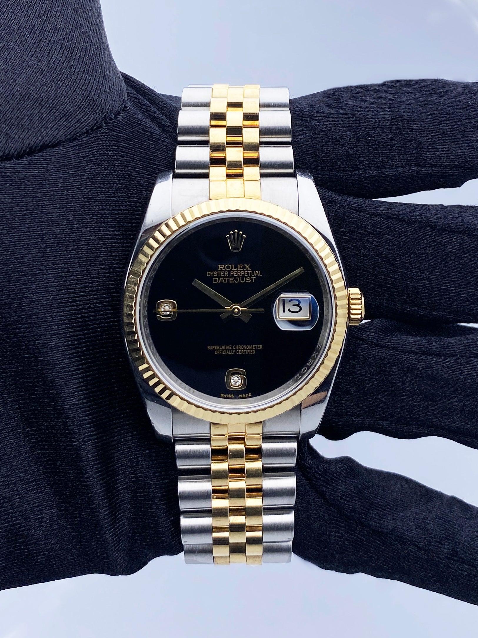 Rolex Oyster Perpetual Datejust 116233 Mens Watch. 36mm stainless steel case with 18K yellow gold fluted bezel. Black onyx dial with gold hands. Gold Arabic numeral with factory diamond hour marker number 6 and 9. Date display at 3 o'clock