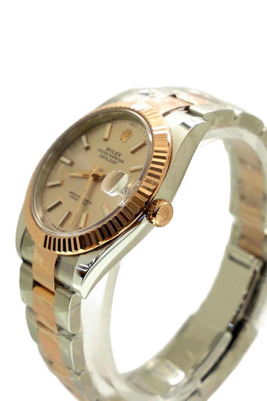 Introducing the brand new 2023 Rolex Datejust126331 in stunning Sun Dust Rose Steel, featuring the iconic Oyster fluted bezel. This elegant 41 mm timepiece masterfully combines Rolex’s timeless design with contemporary sophistication, making it a