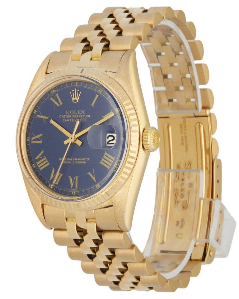 Rolex Datejust 1601 Men's Watch. 36mm 18k Yellow gold case. 18K Yellow Gold fluted bezel. Blue dial with gold luminous hands and Roman numeral hour markers.Minute markers on the outer dial. Date display at the 3 o'clock position. 18K Yellow Gold